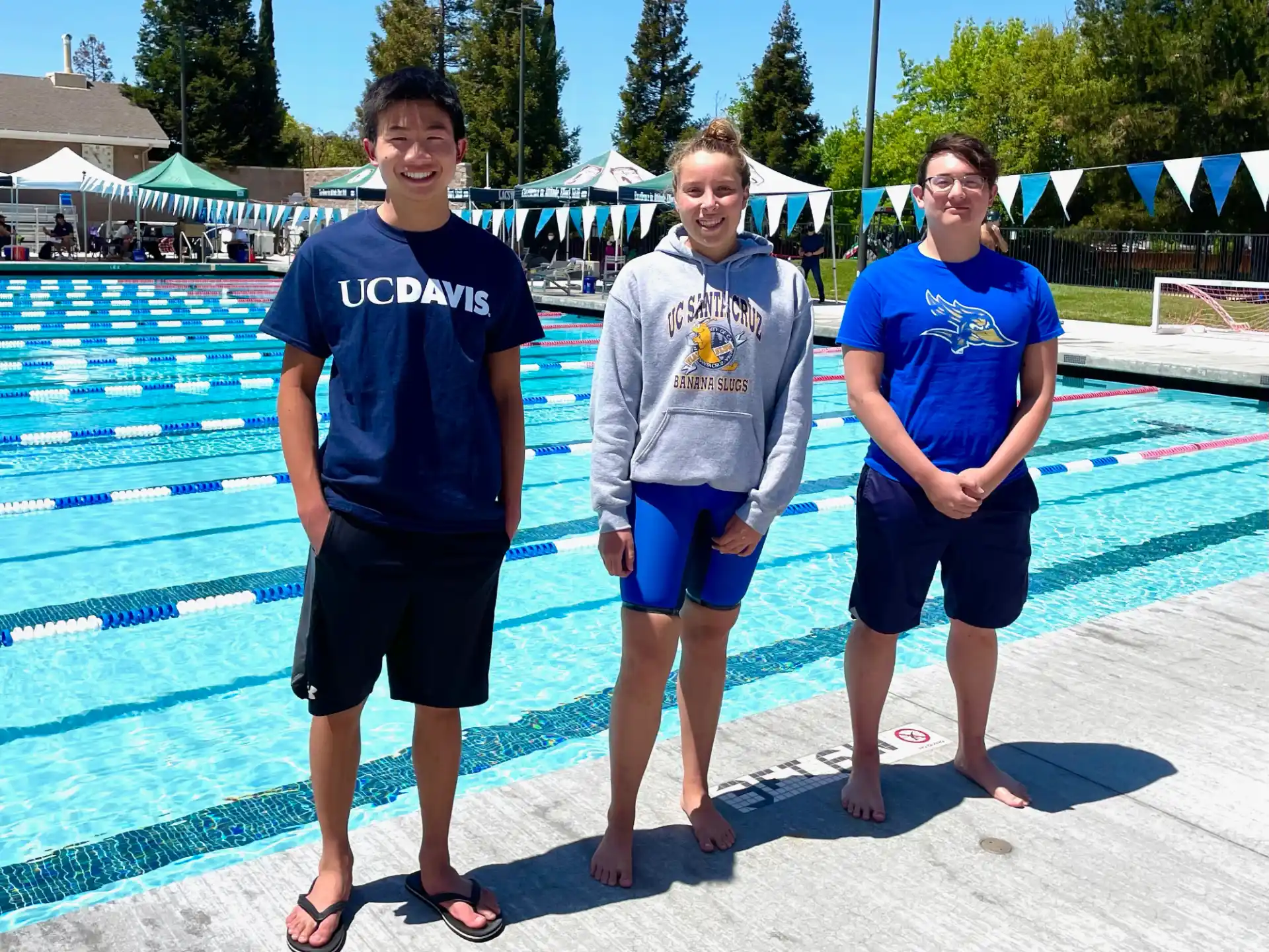a group of people posing for a photo by a pool