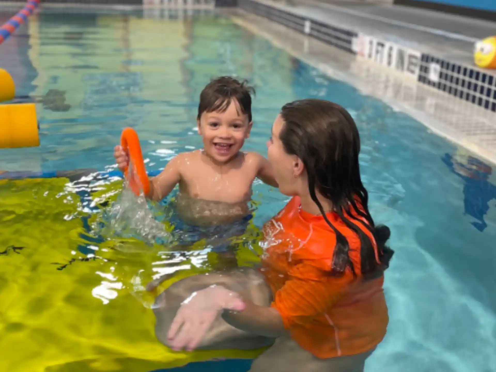 a boy and girl in a pool
