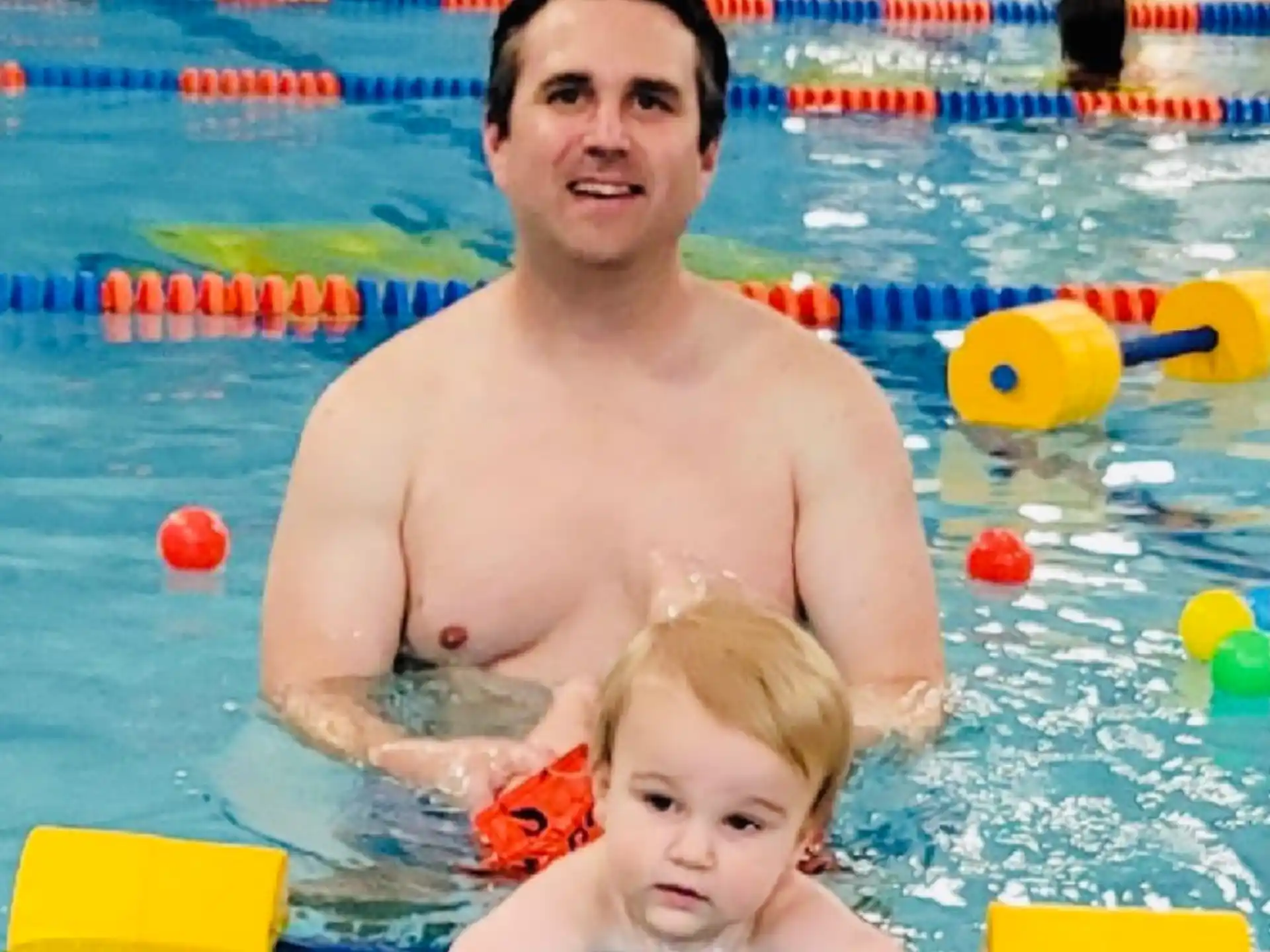 a person and a child in a pool