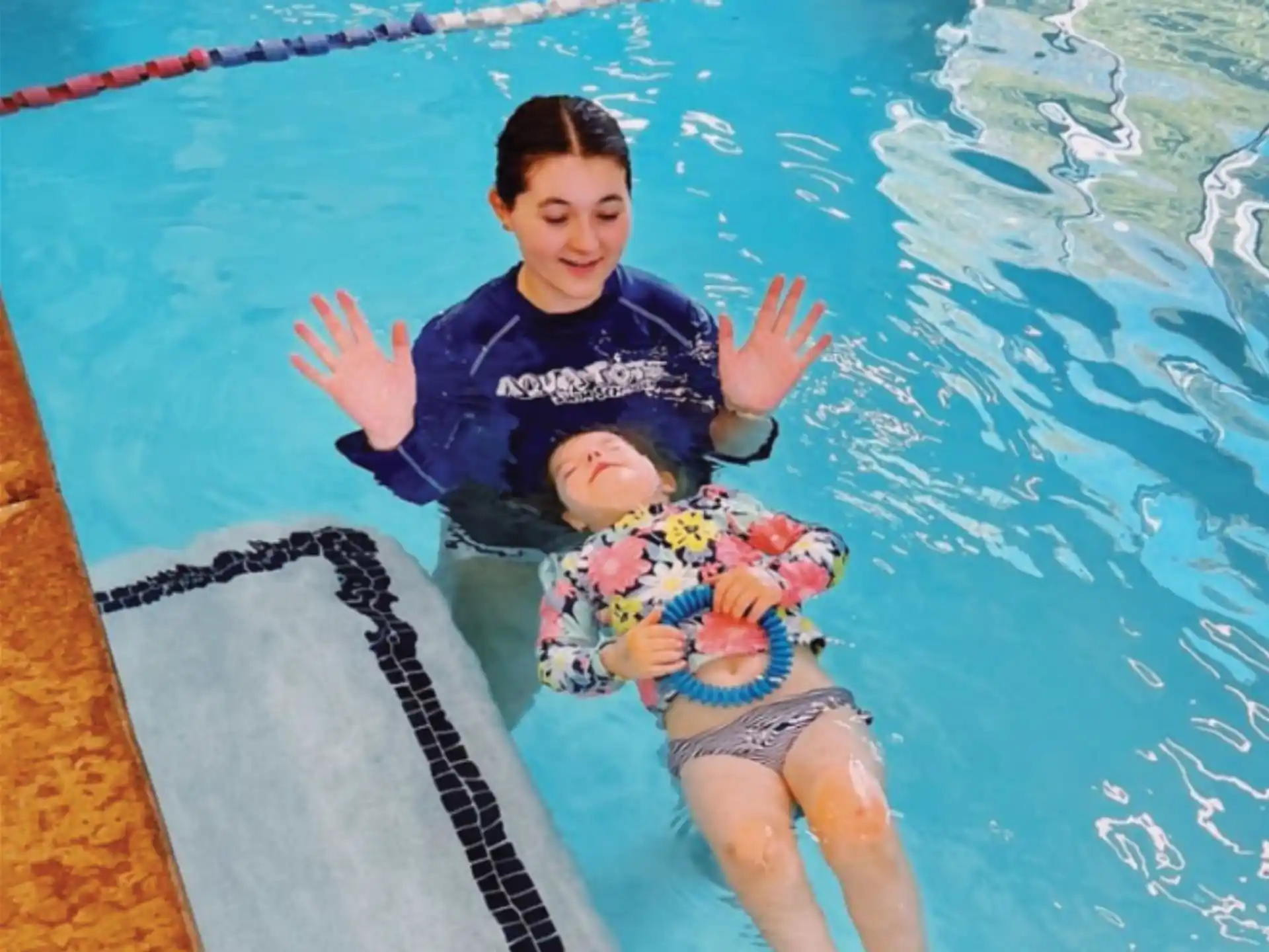 a person and a baby in a pool