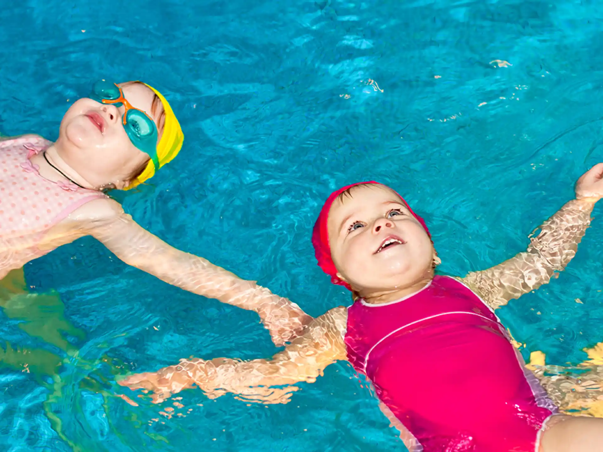 a couple of kids in a pool