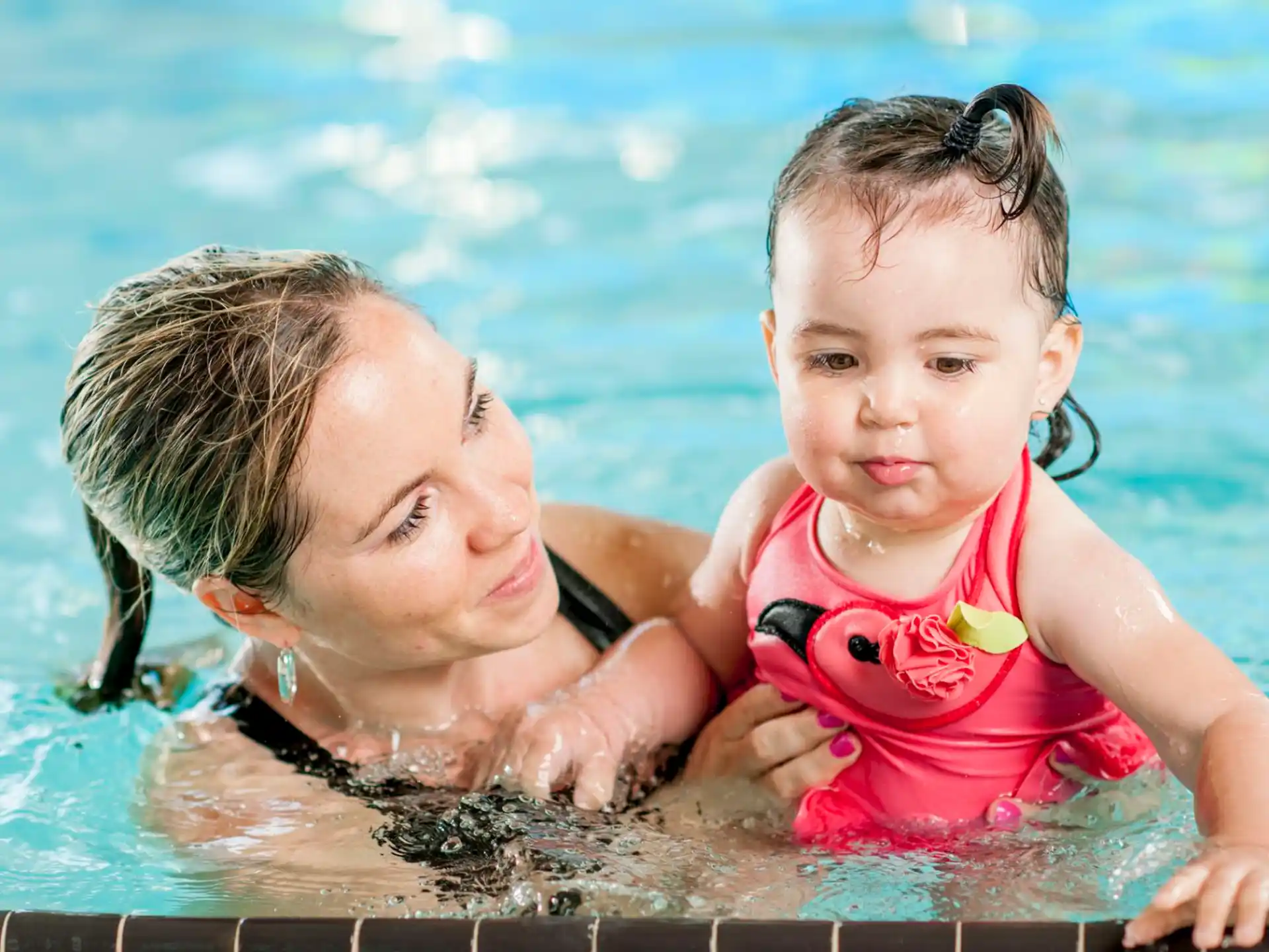 a person and a baby in a pool