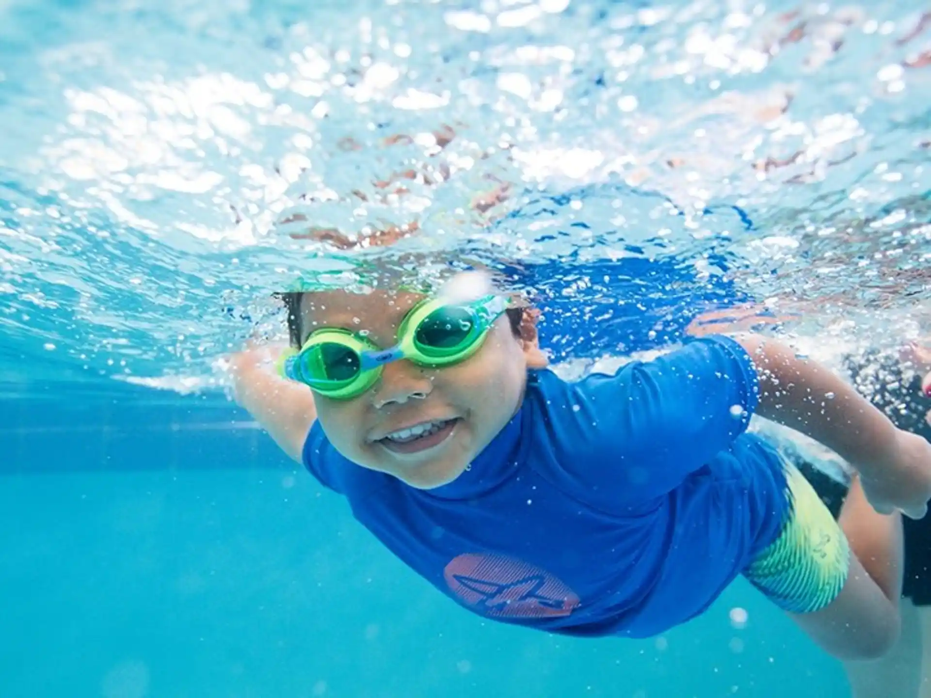 a person wearing goggles and swimming