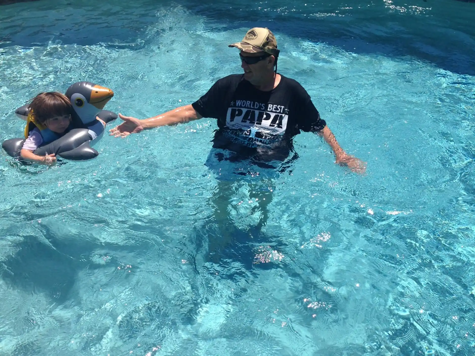 a man and a child in a pool