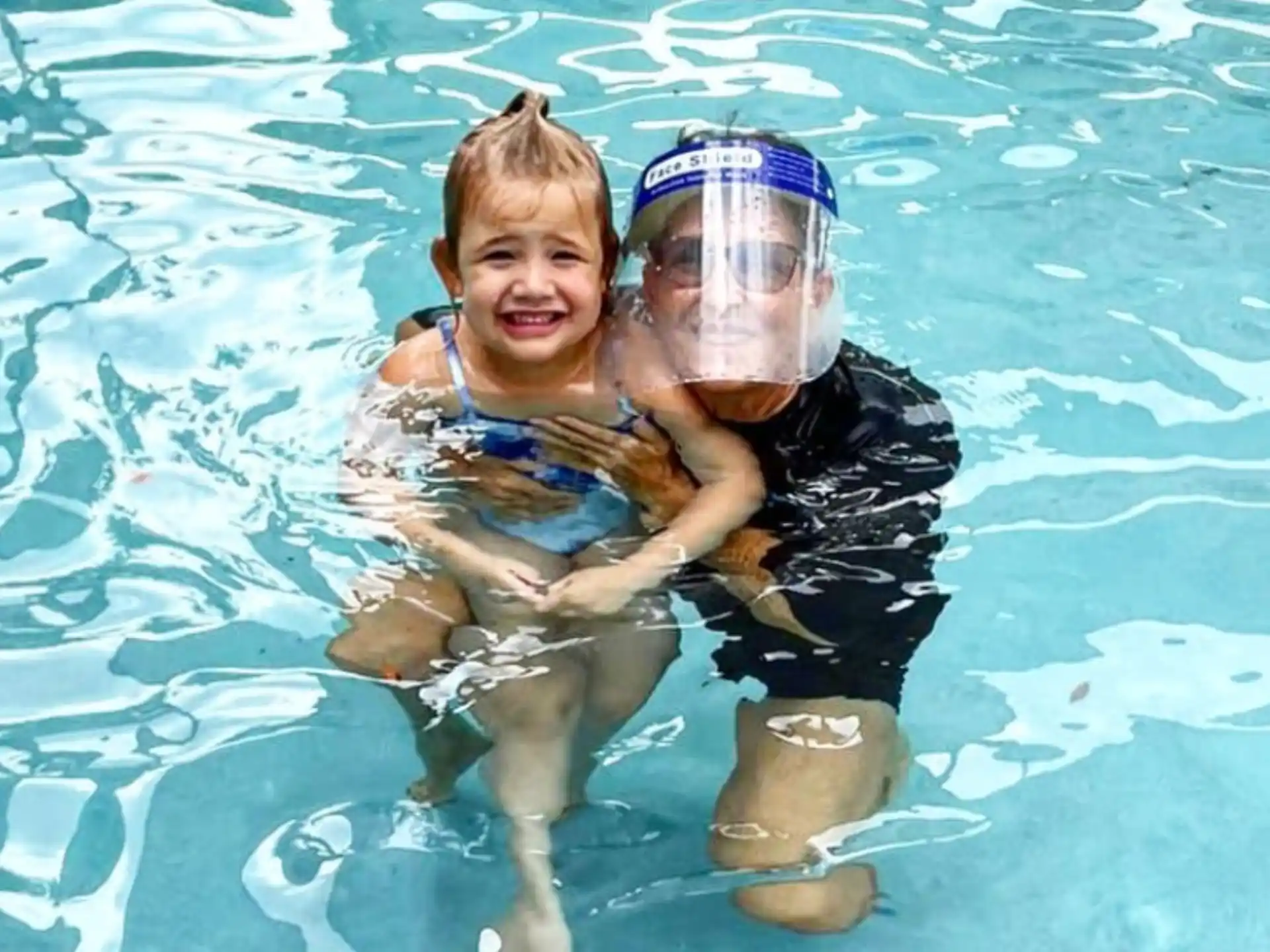 a boy and a girl in a pool