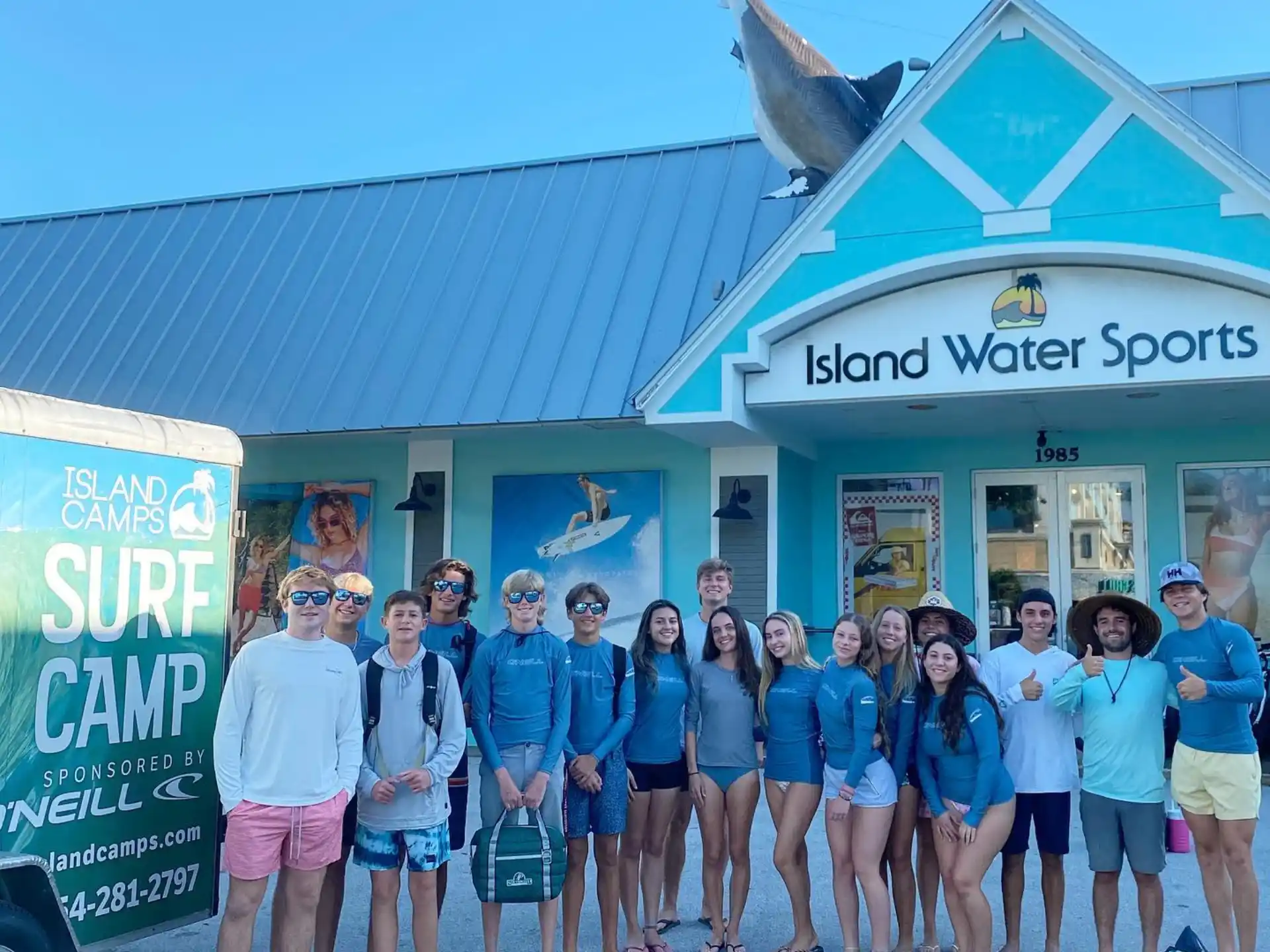a group of people posing for a photo in front of a building