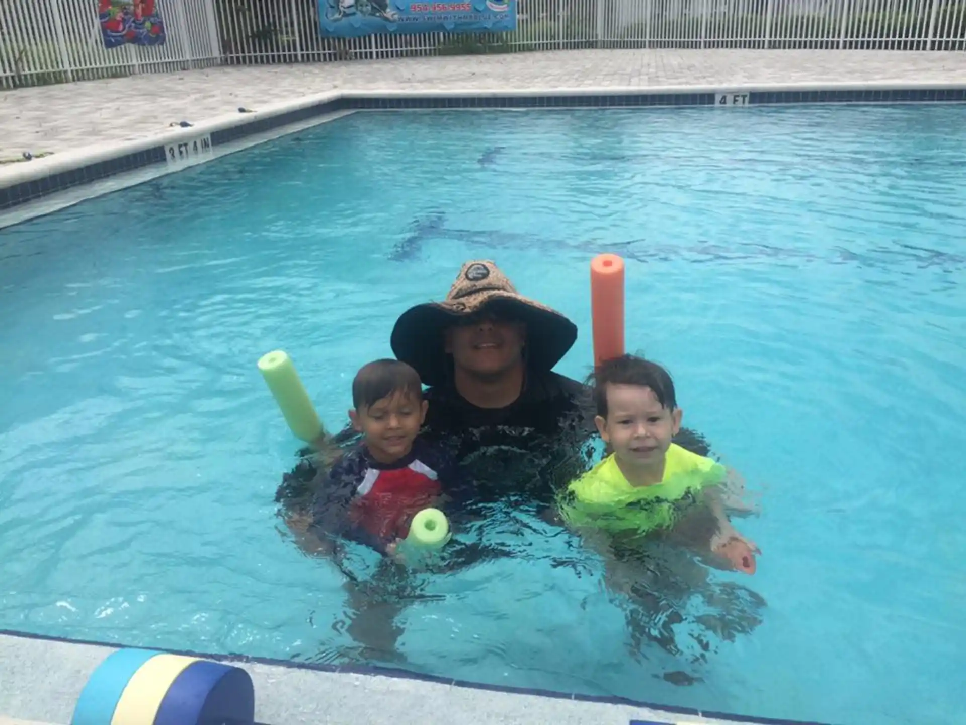 a person and two children in a pool