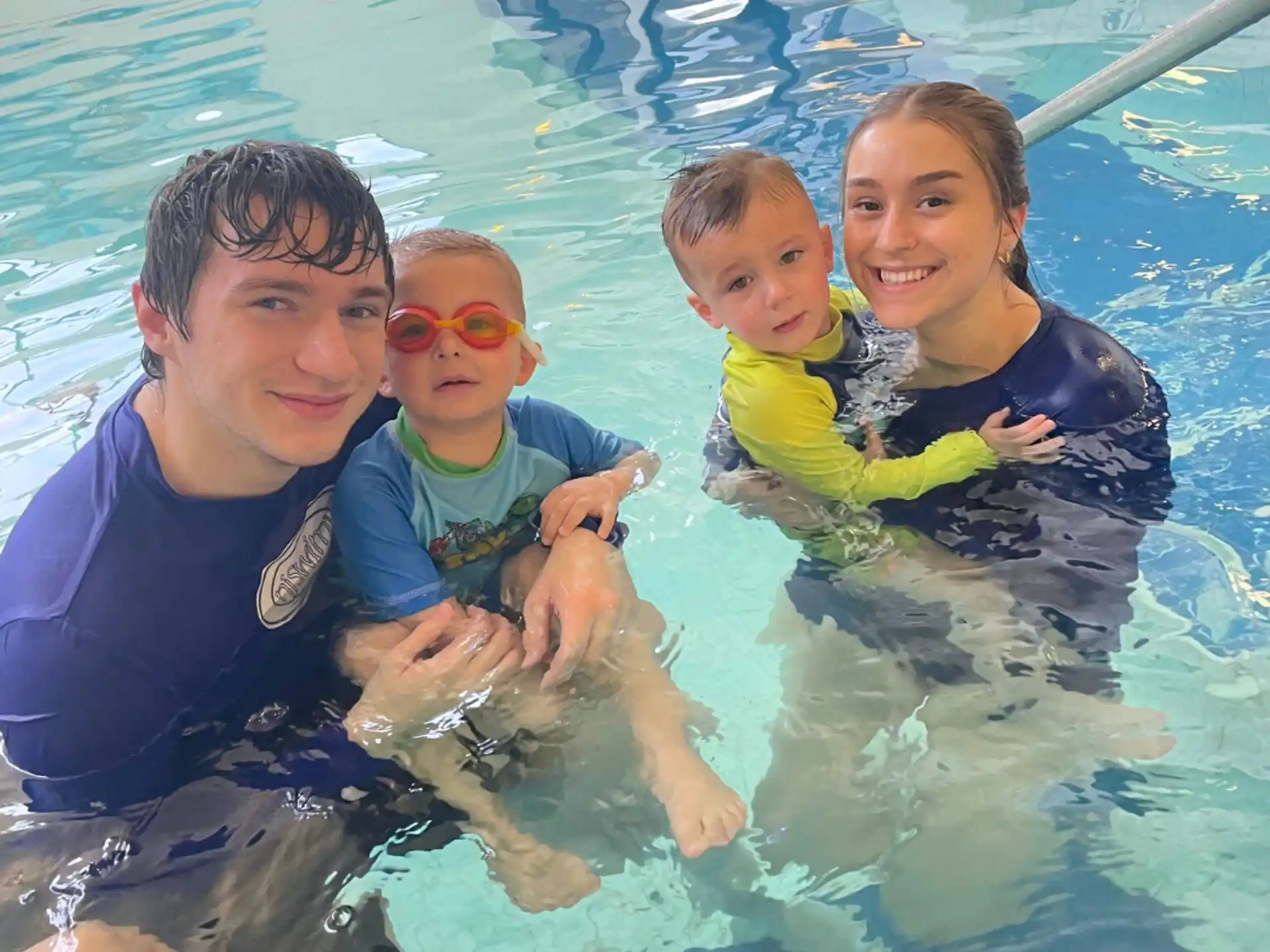 a group of people in a pool with a dog