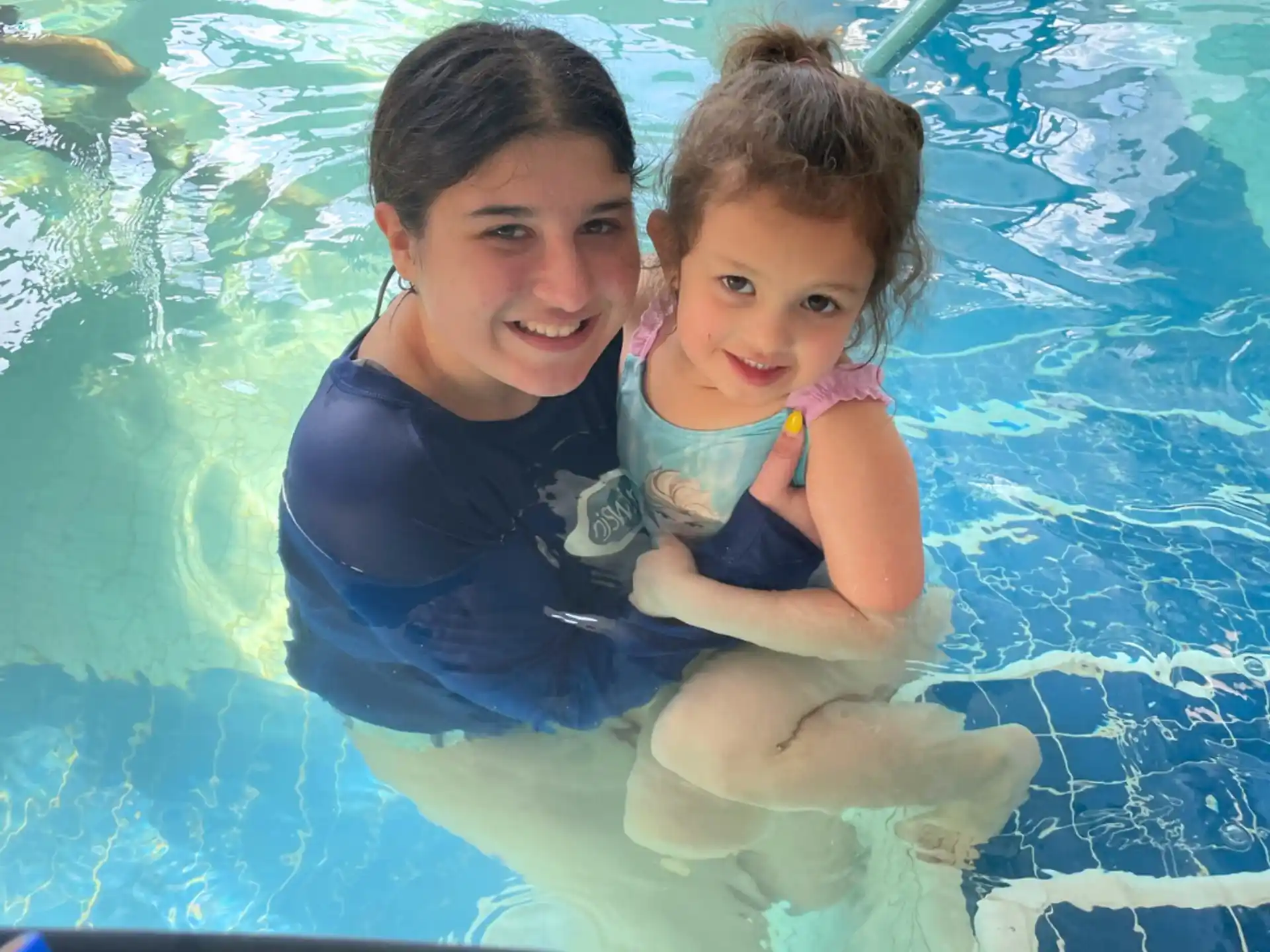 a person and a child in a pool