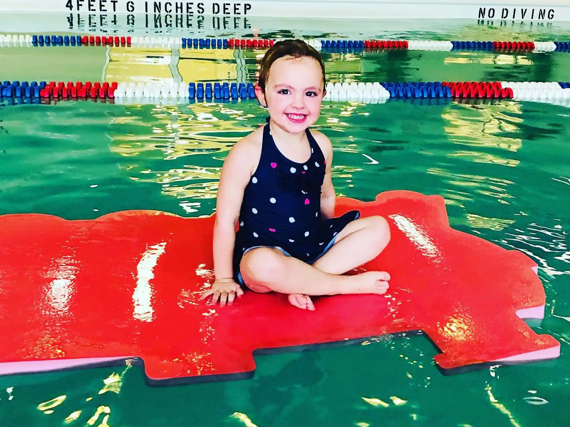 a child sitting in a pool