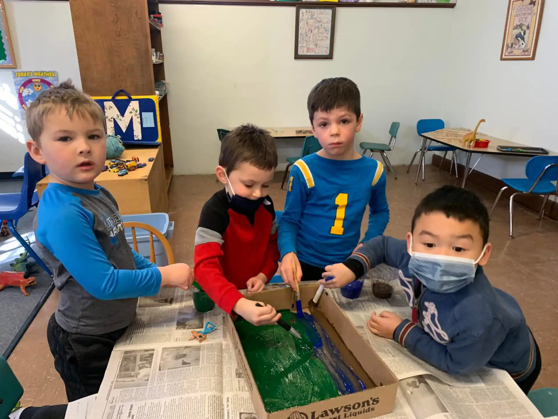 a group of boys sitting at a table