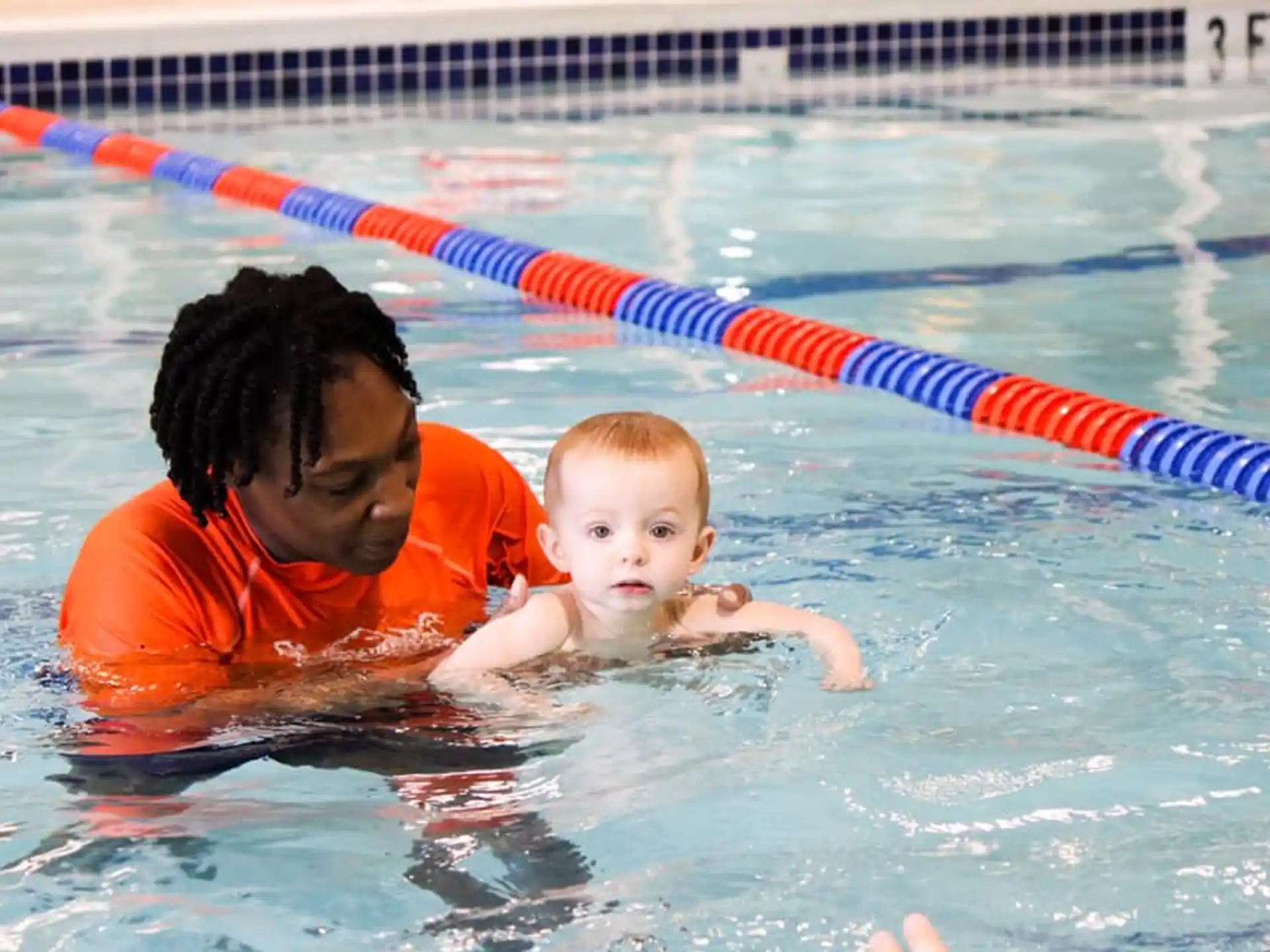 a person and a baby in a pool