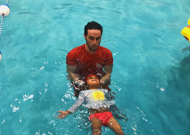 a man and a child in a pool