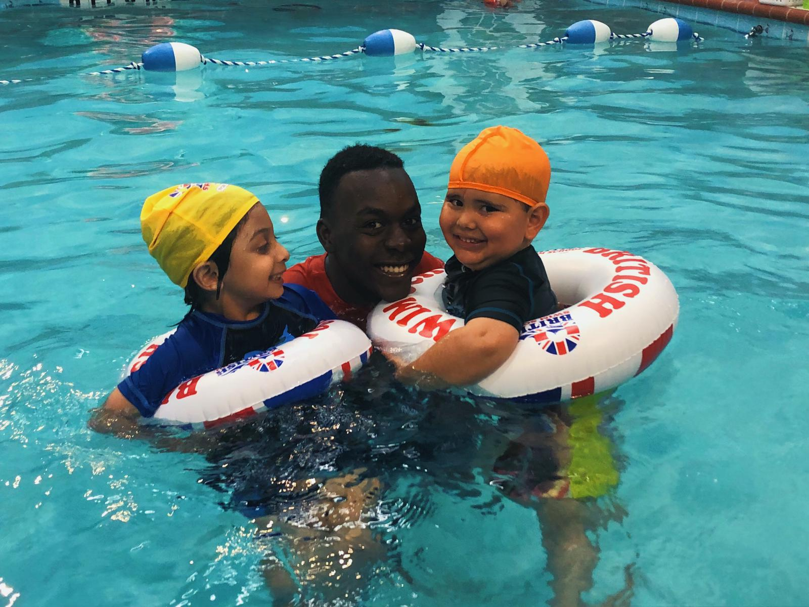 a man and two boys in a pool