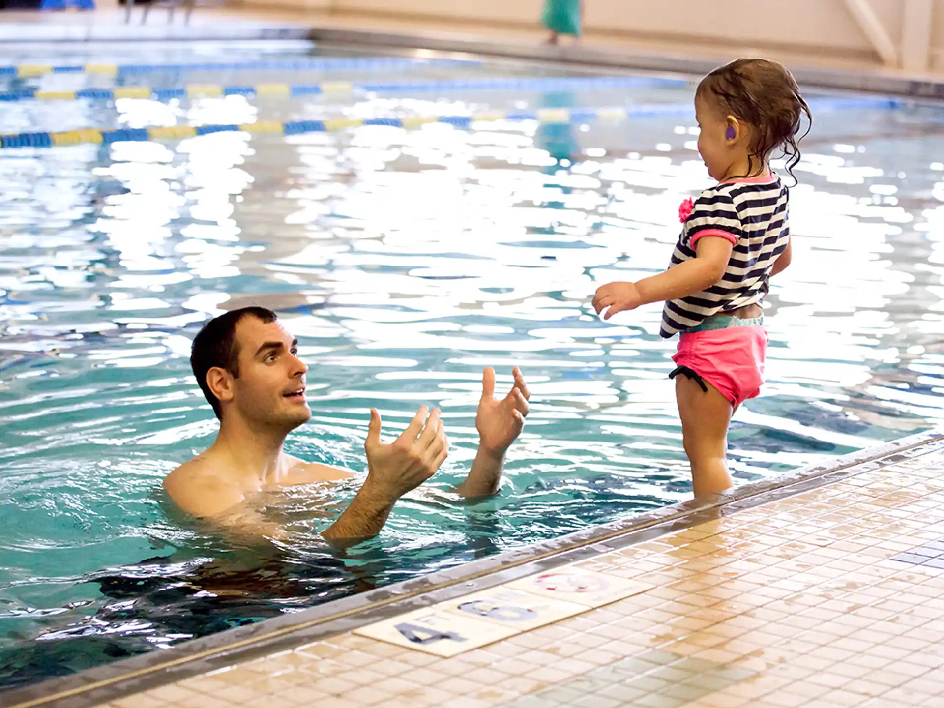 a person and a child in a swimming pool