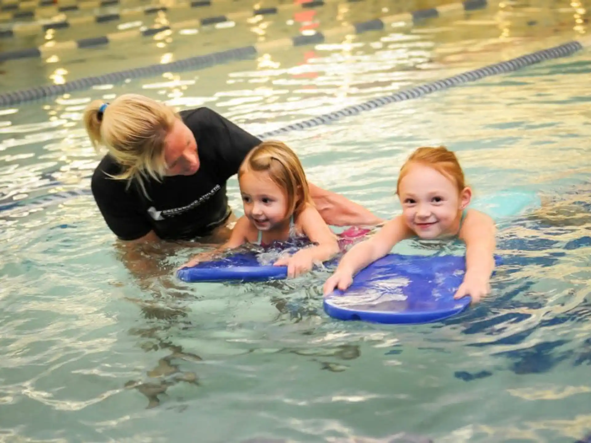a person and a couple of girls in a pool
