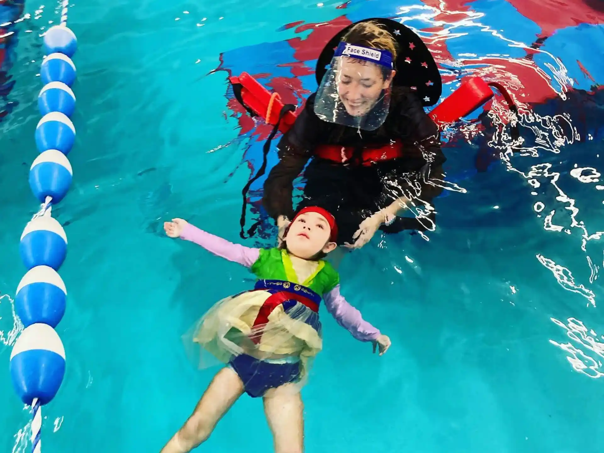 a person and a child in a pool