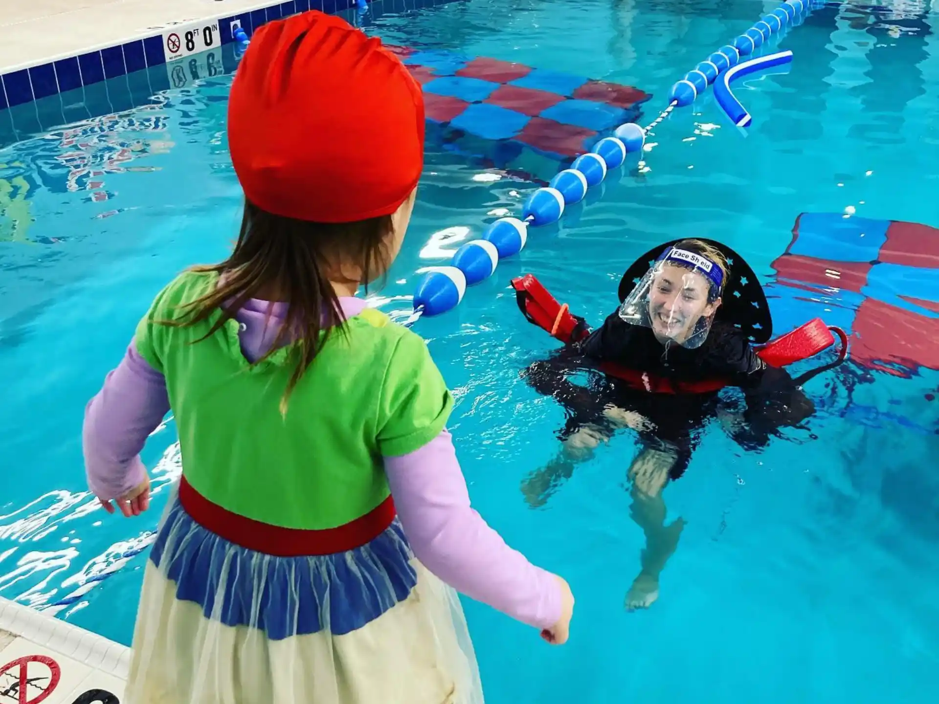 a person and a child in a pool