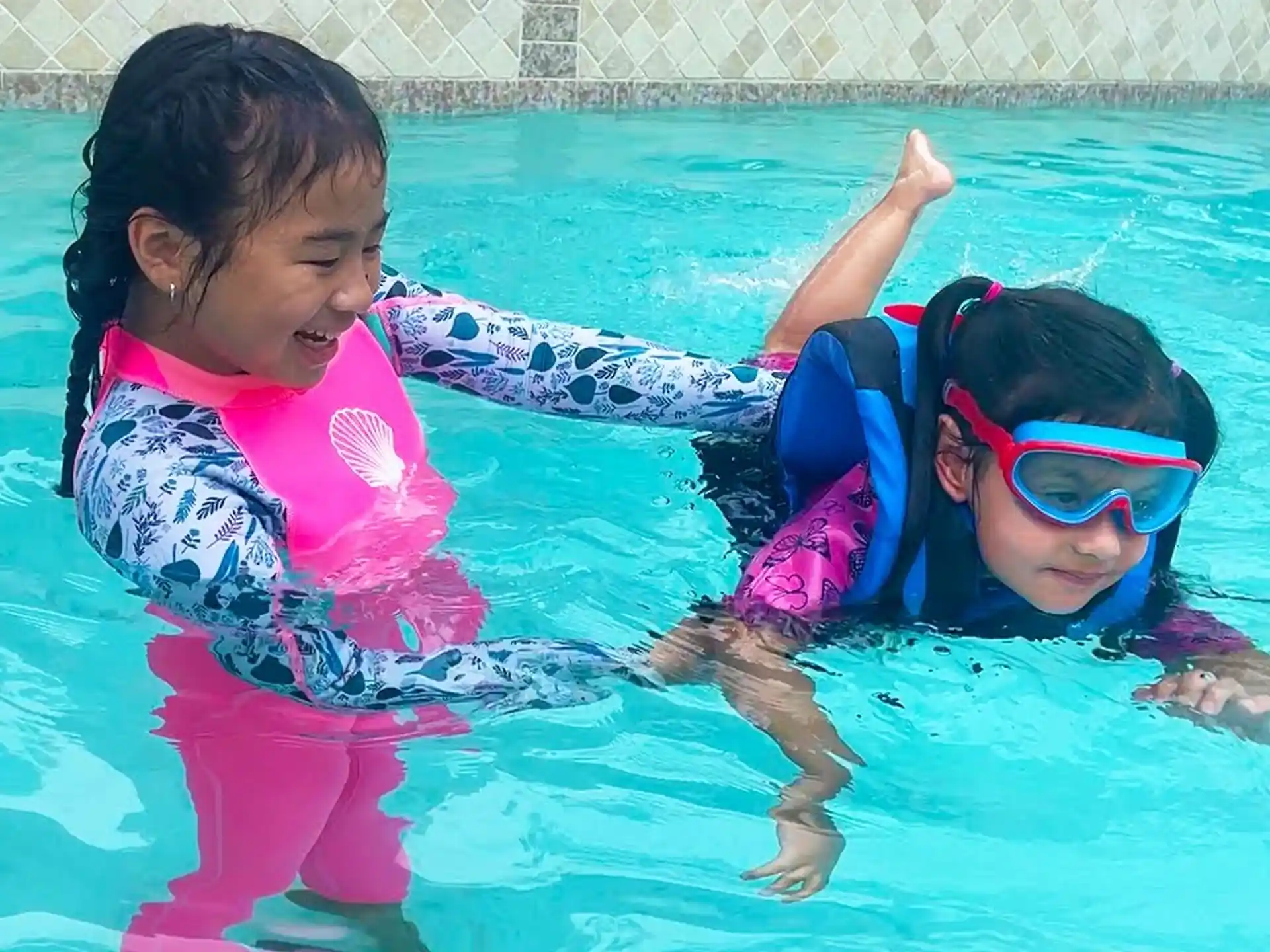 a couple of girls in a pool