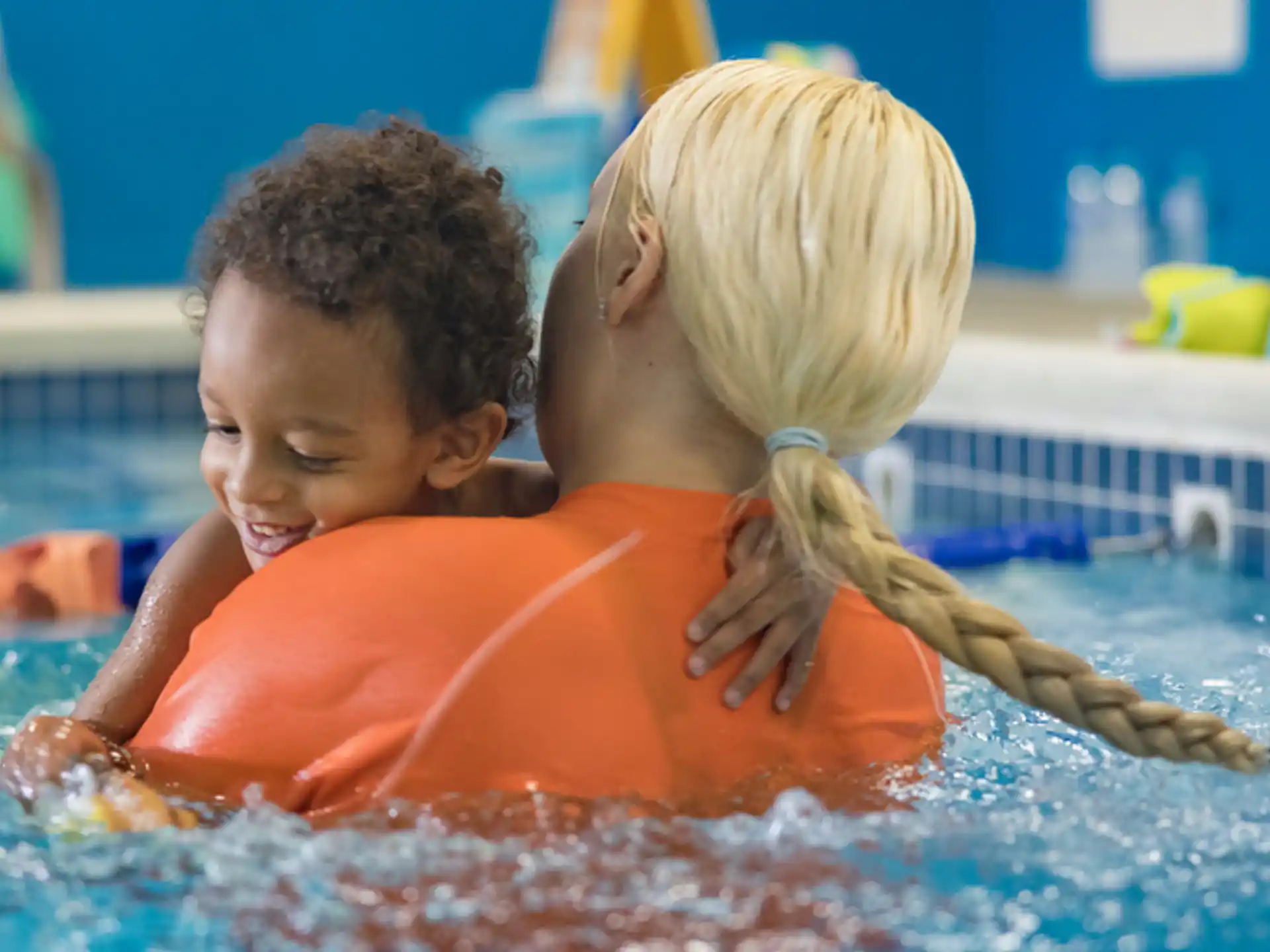 a boy and girl in a pool