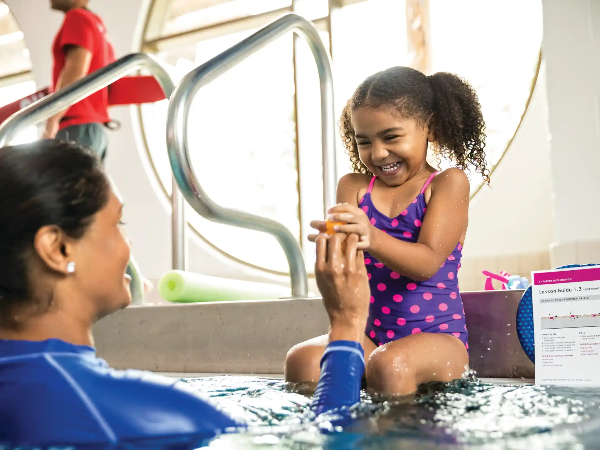 a person and a child in a pool