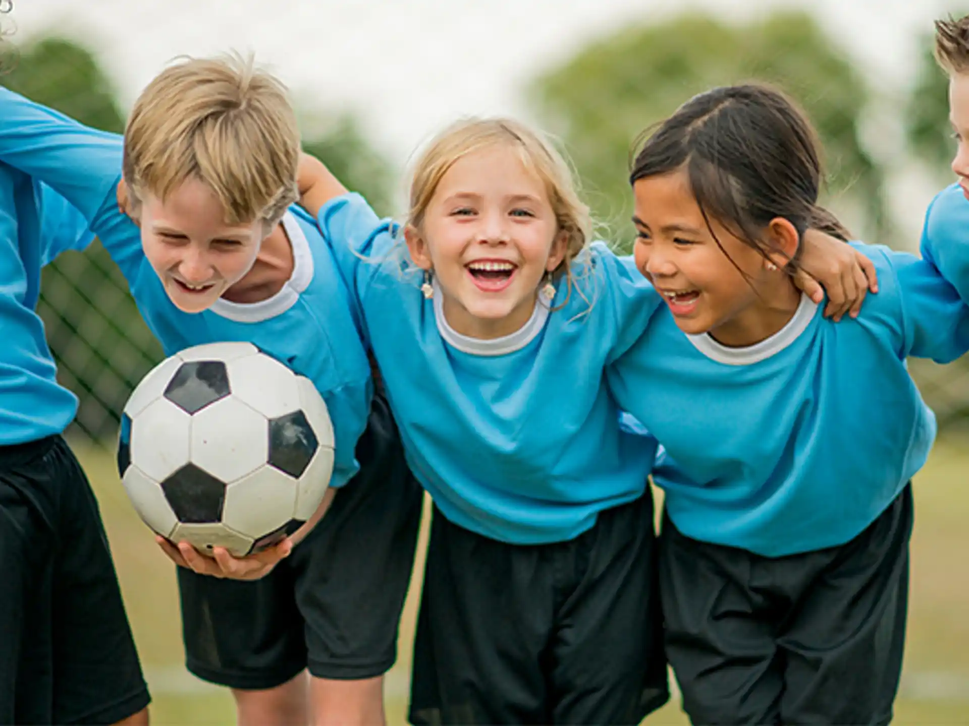 a group of kids playing football