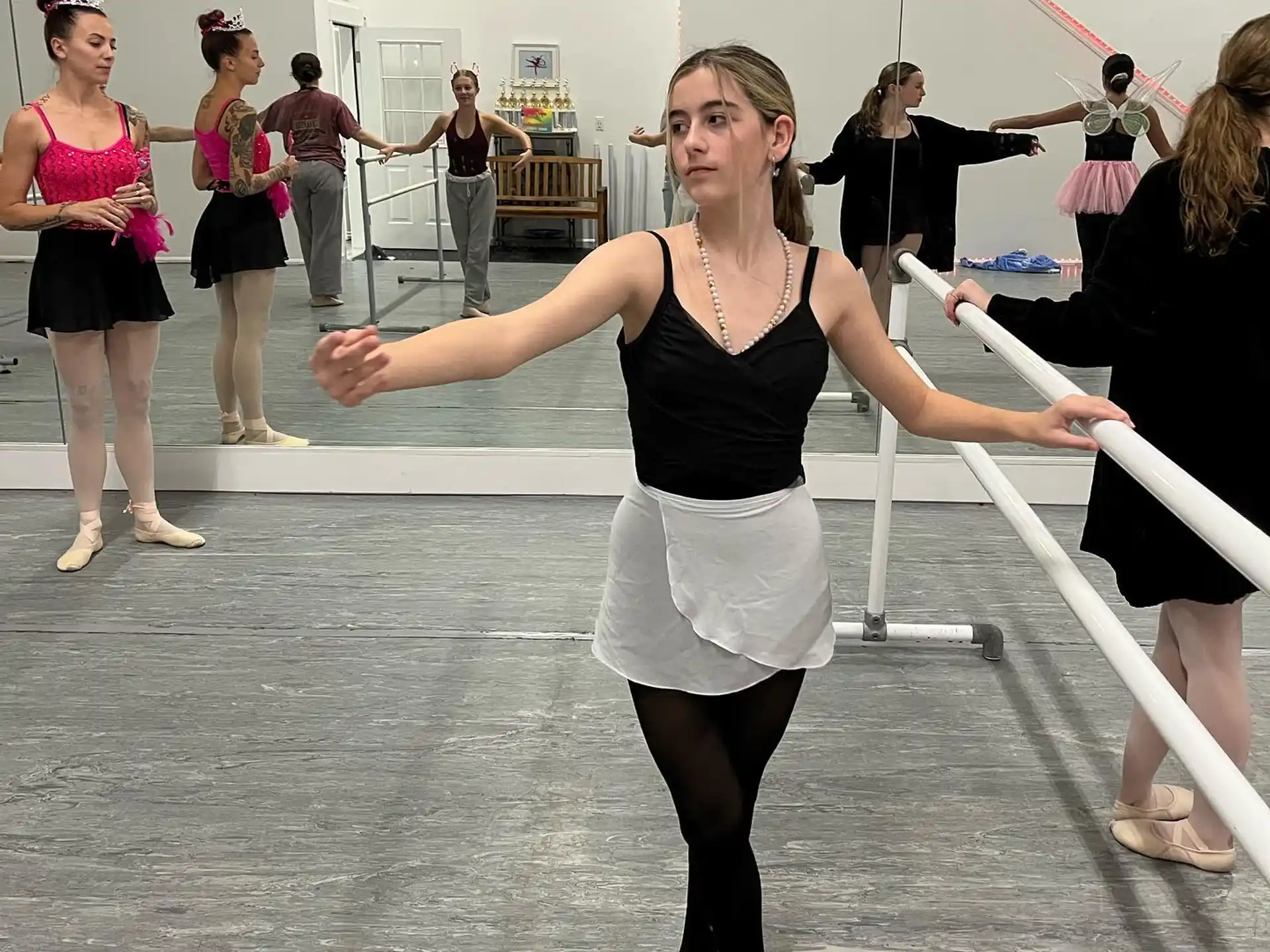 a woman dancing in a room with other people