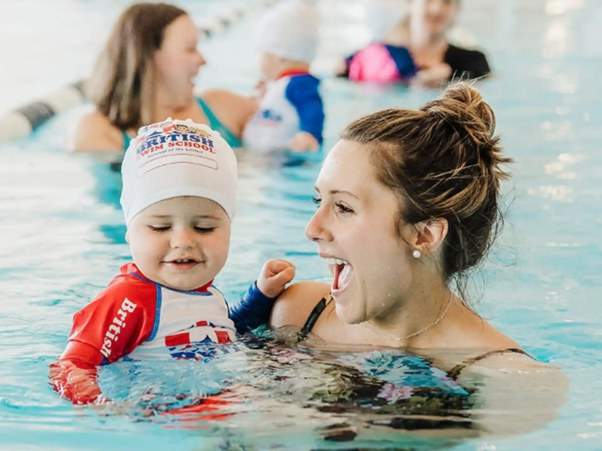 a person and a baby in a pool
