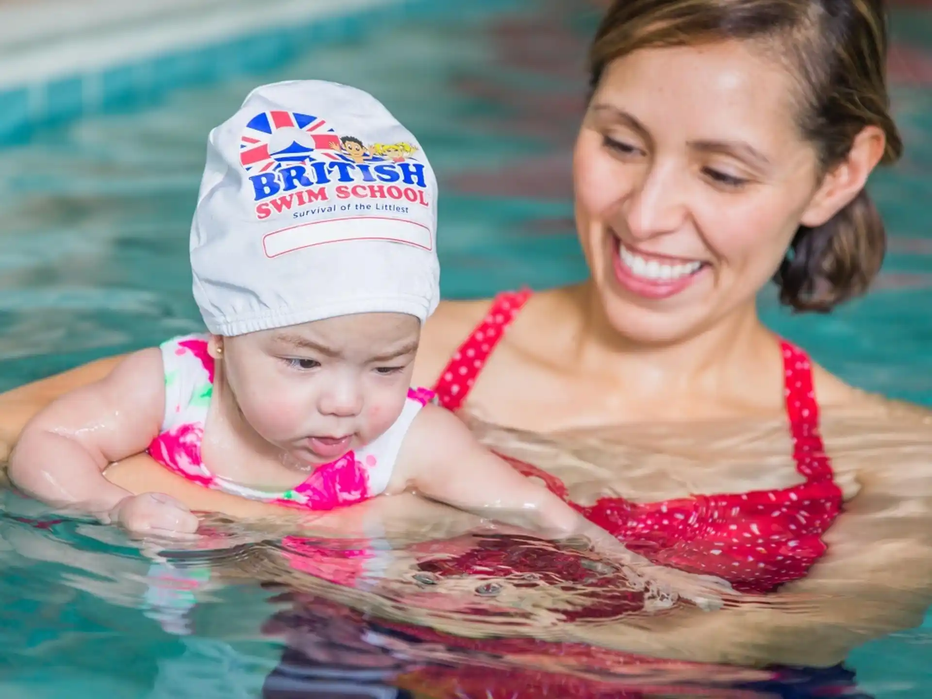 a person and a baby in a pool