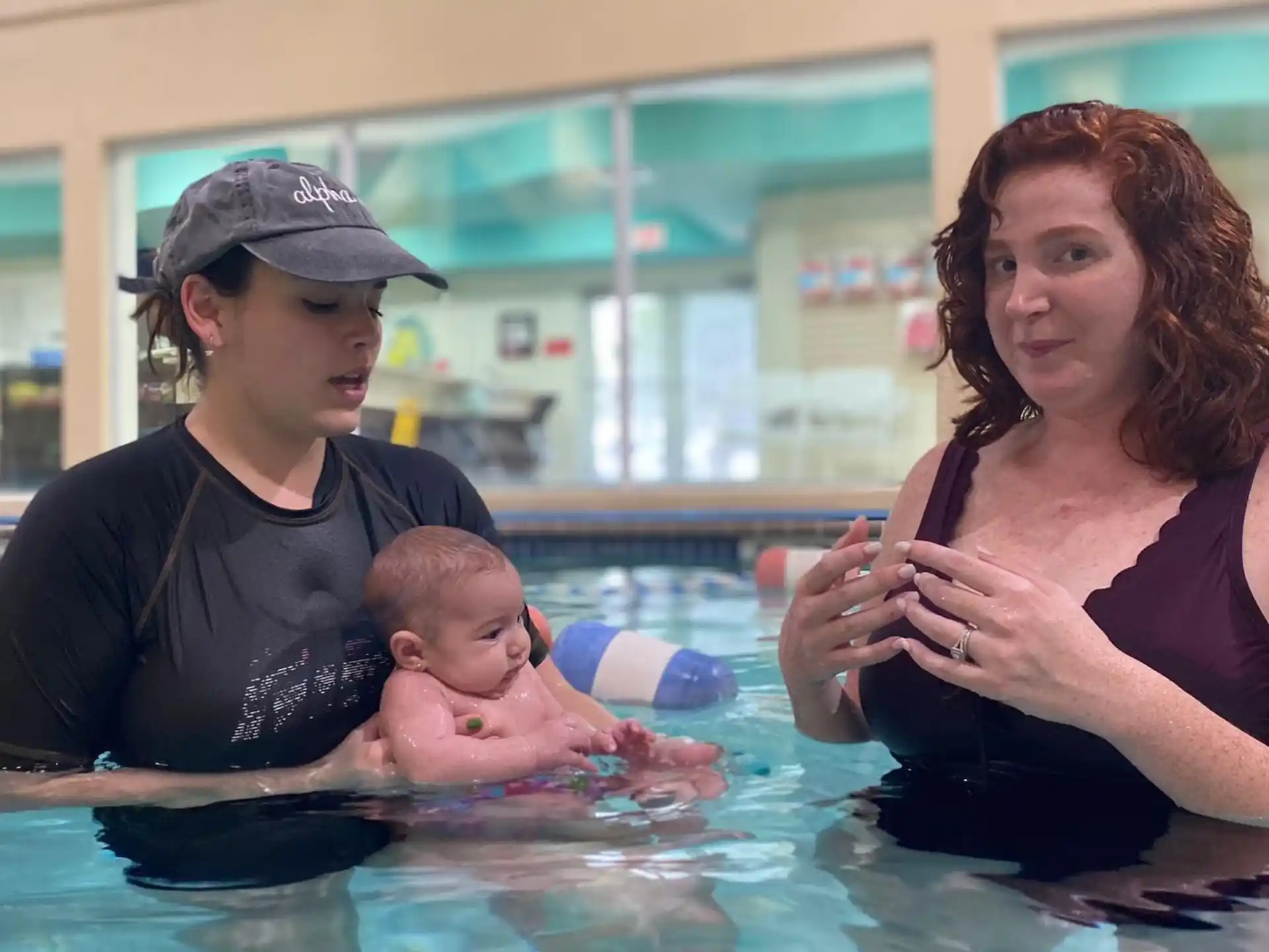 a person and a baby in a pool