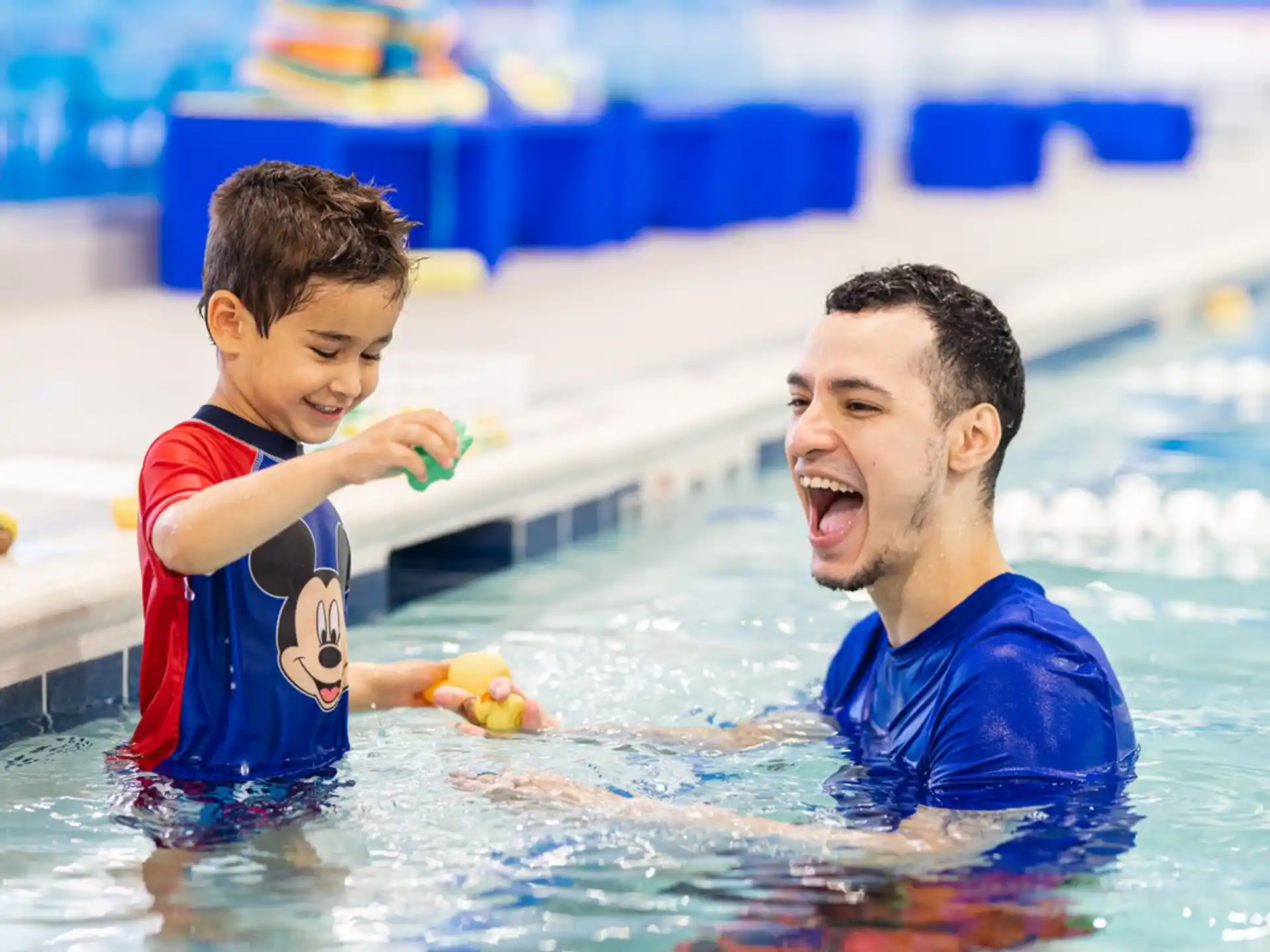 a person and a boy in a pool