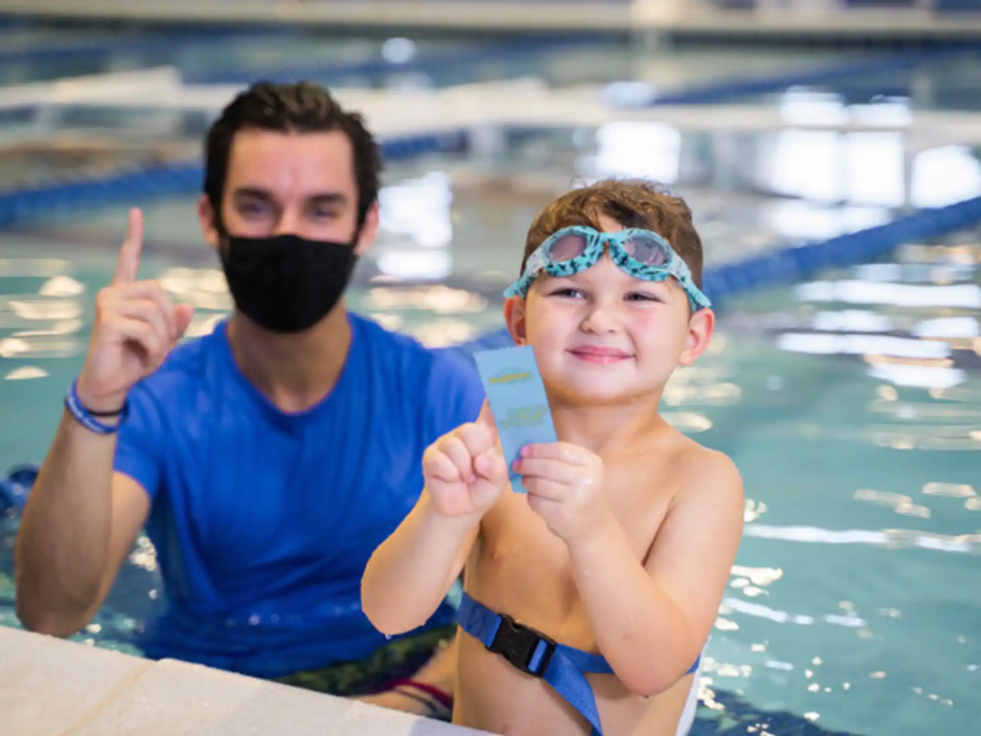 a person and a boy in a pool