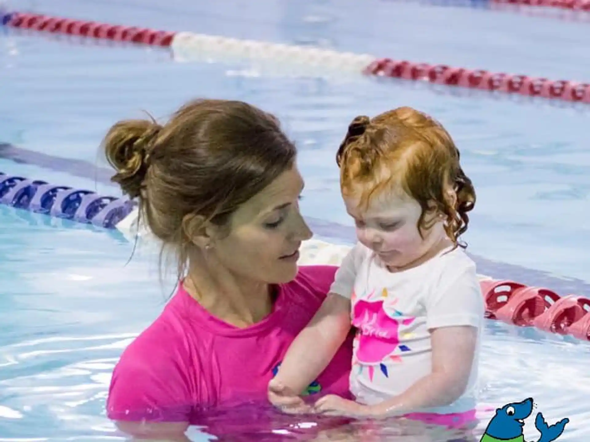 a couple of girls playing in a pool