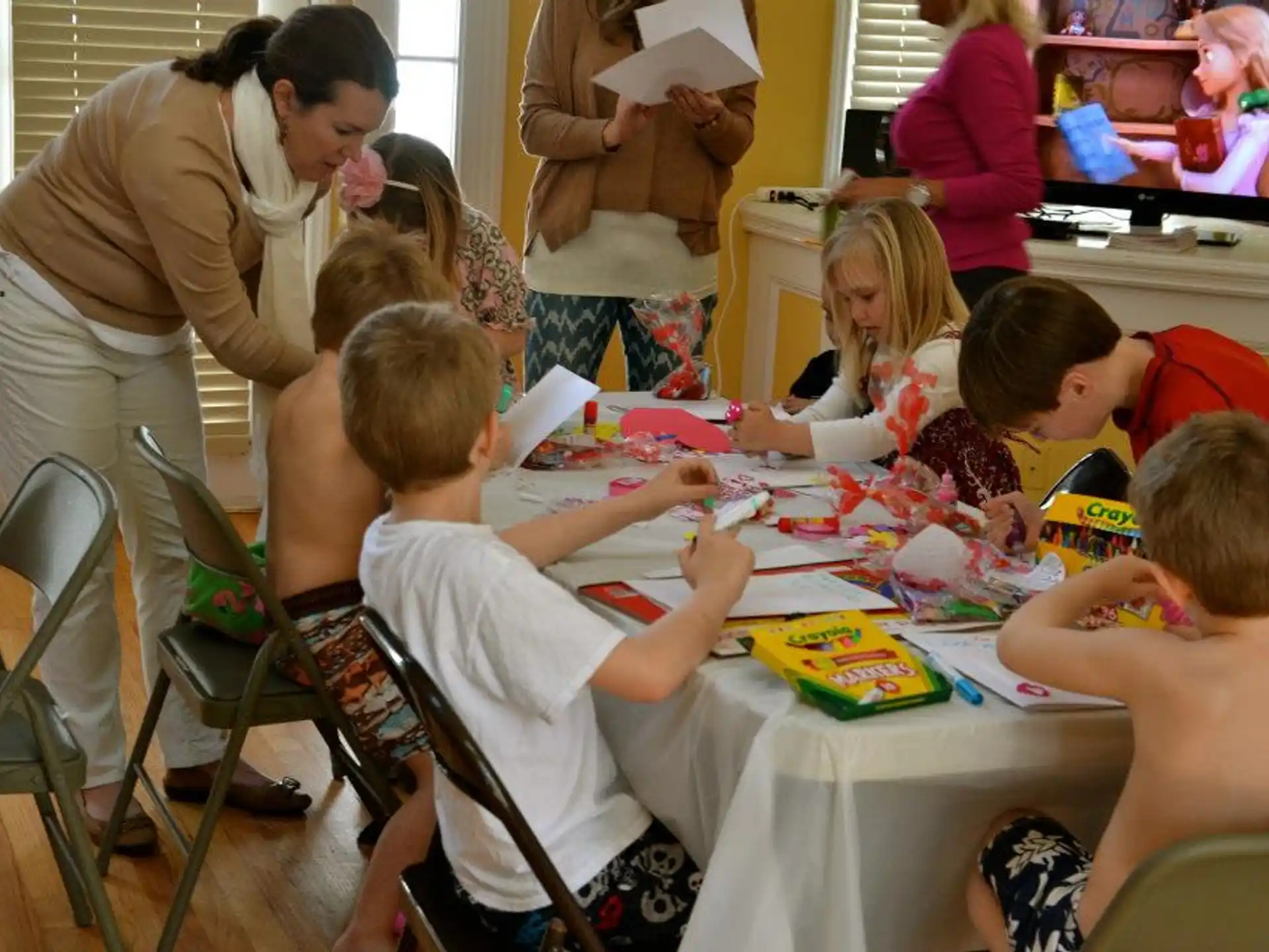 a group of children sitting around a table