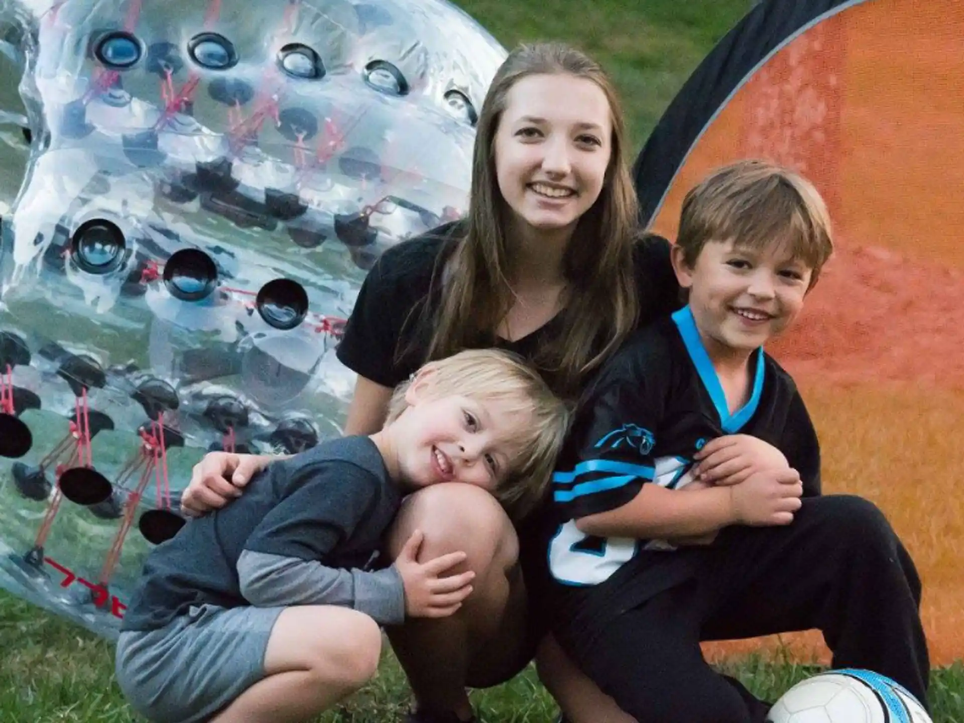 a person and two children posing for a photo in front of a tent