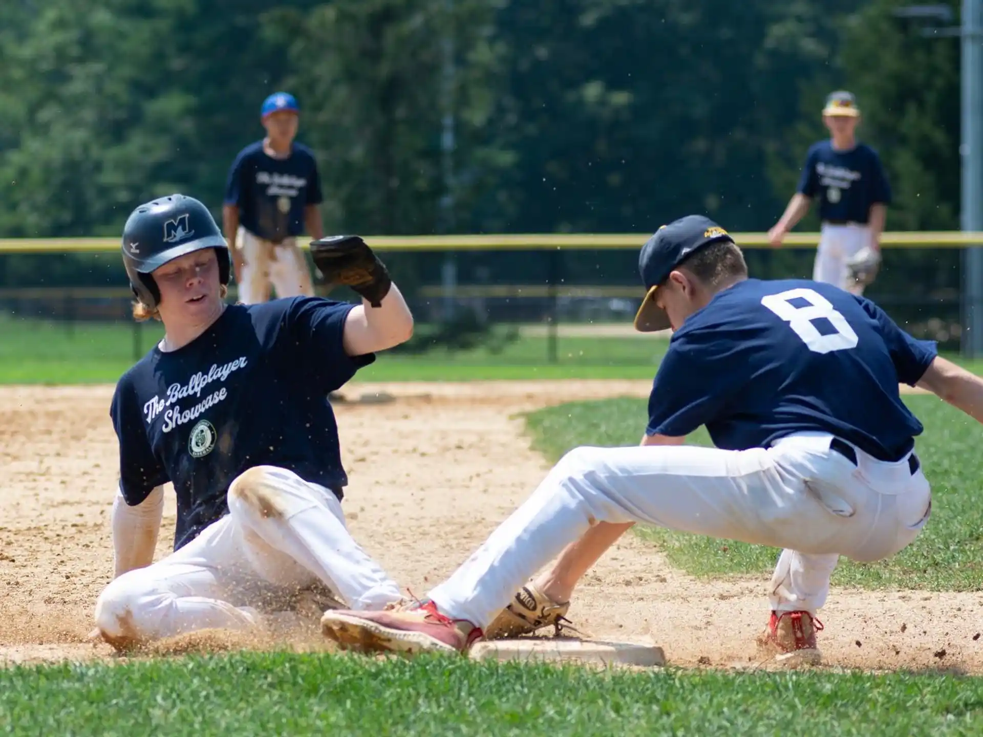 a baseball player sliding into home plate