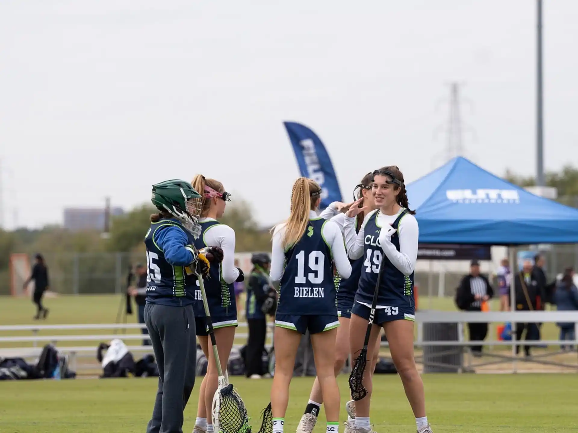 a group of women in sports uniforms on a field