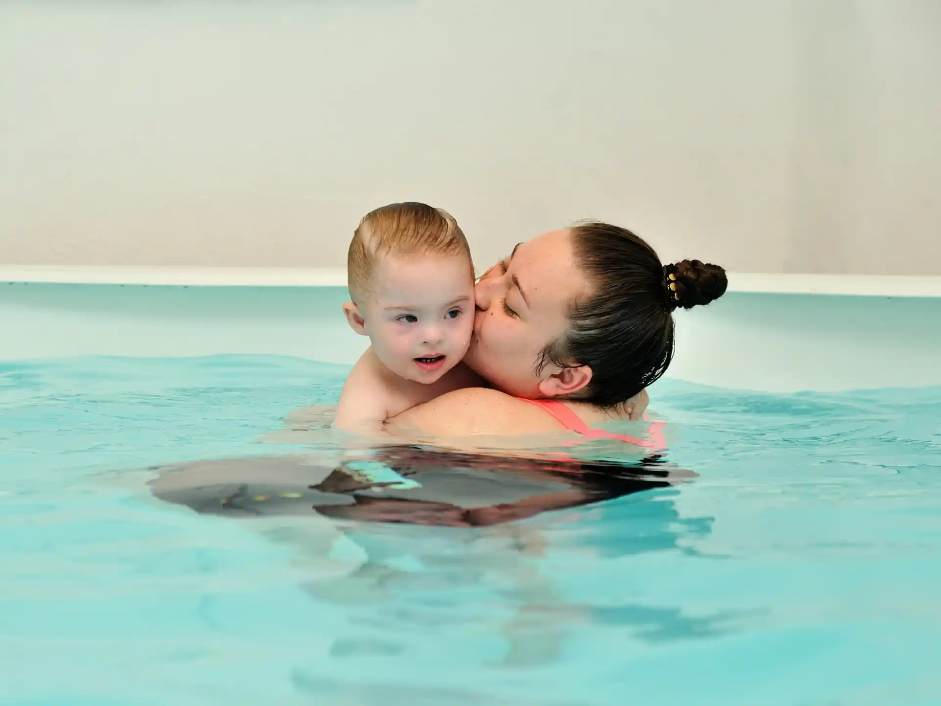 a person and a child in a pool