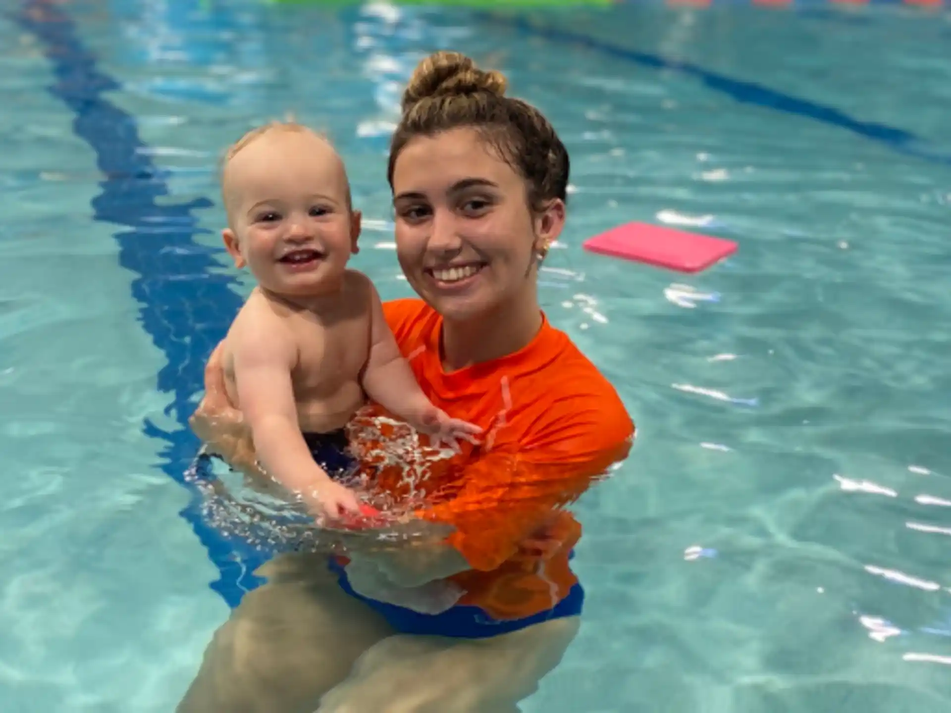 a person and a baby in a pool