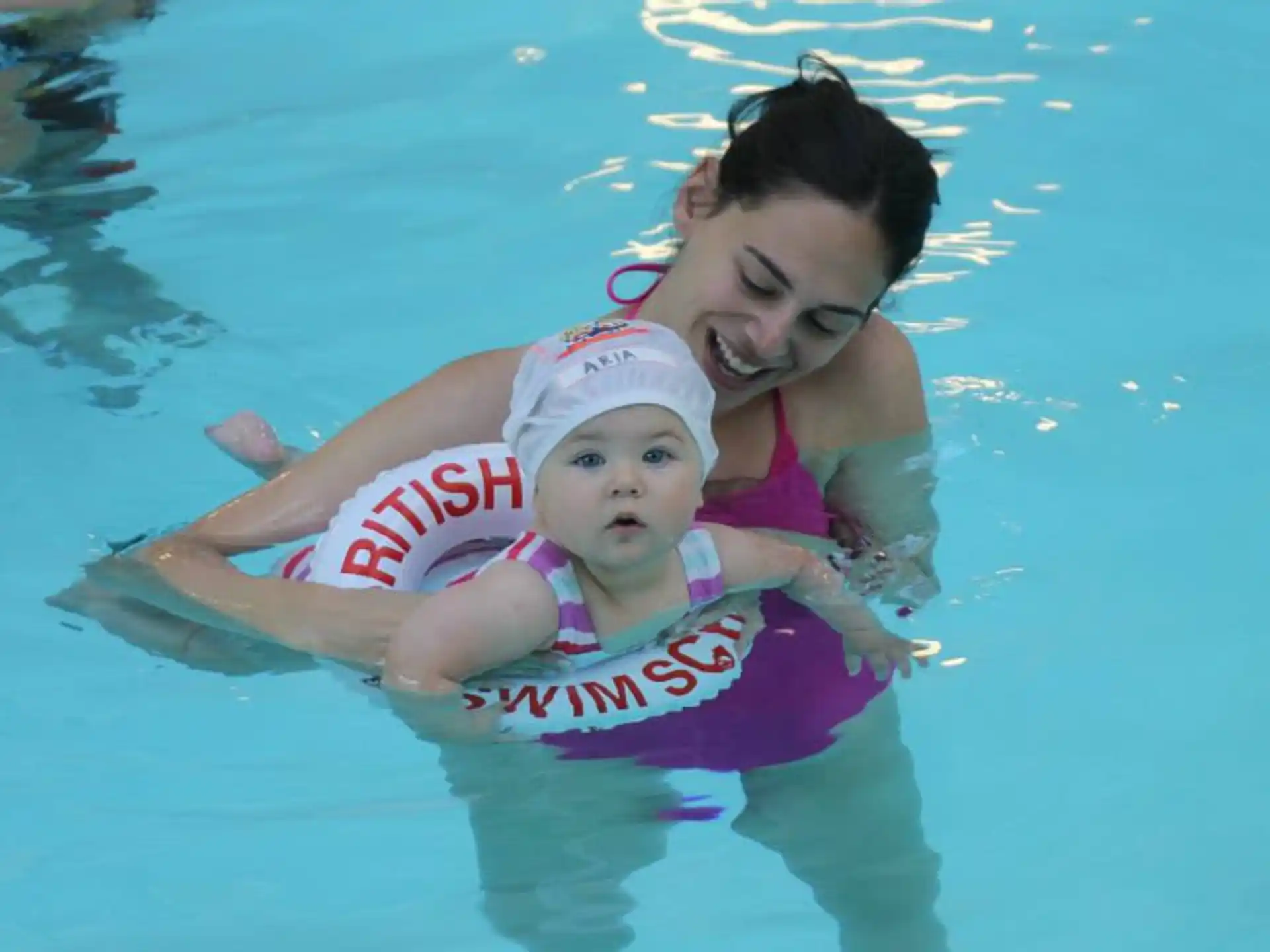 a person and a baby in a pool