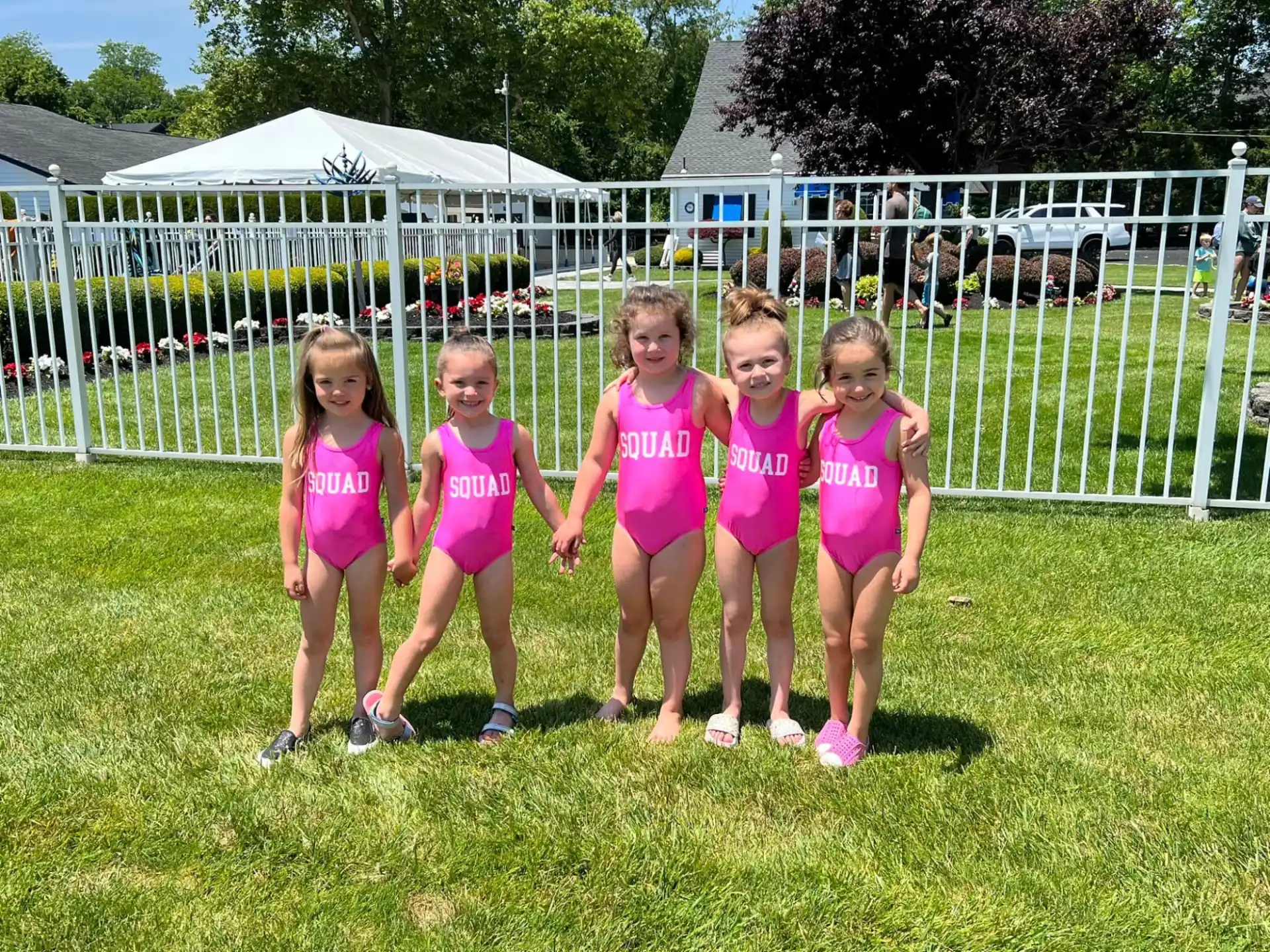 a group of girls in pink shirts