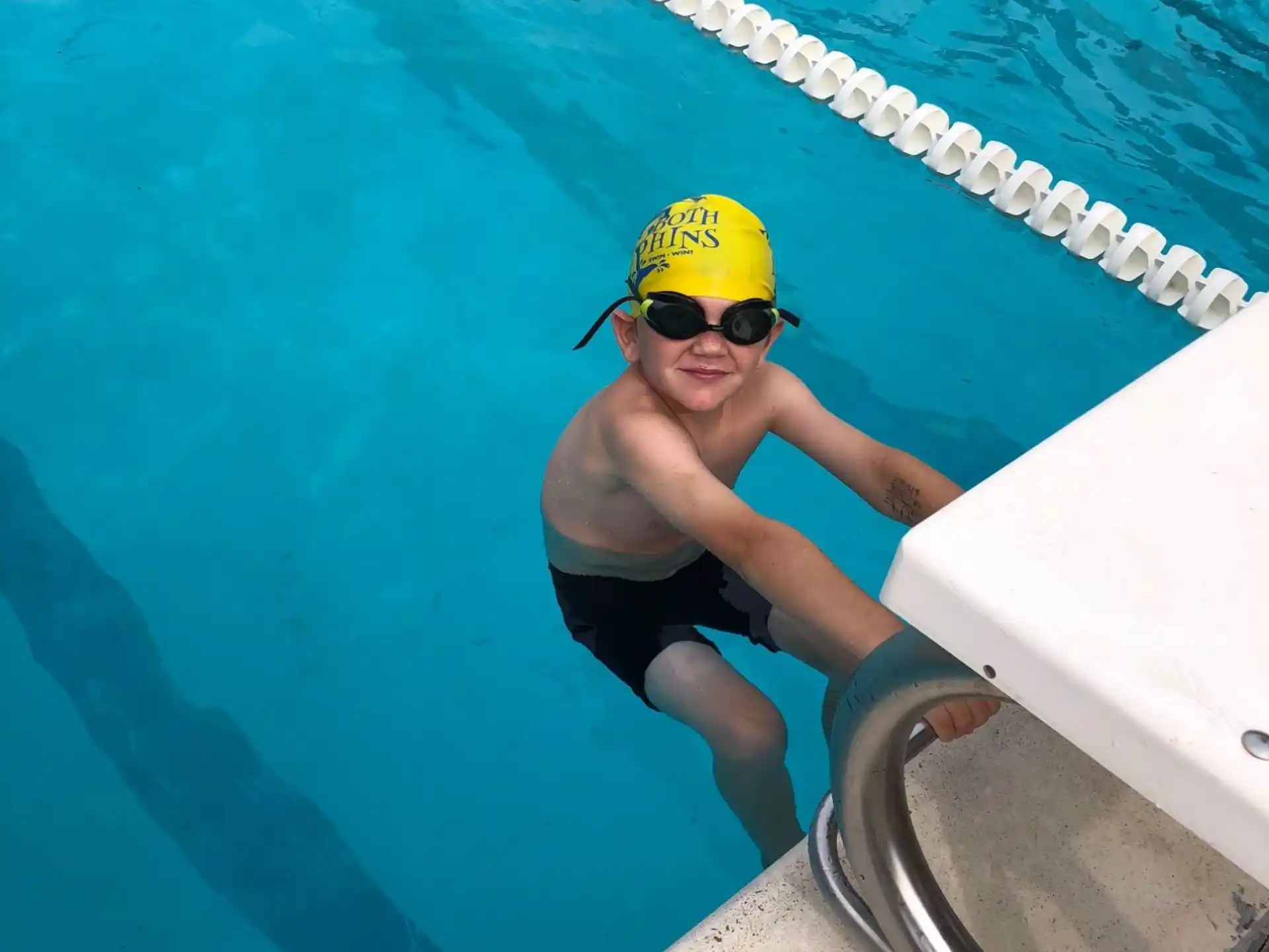 a person in a yellow hat in a pool