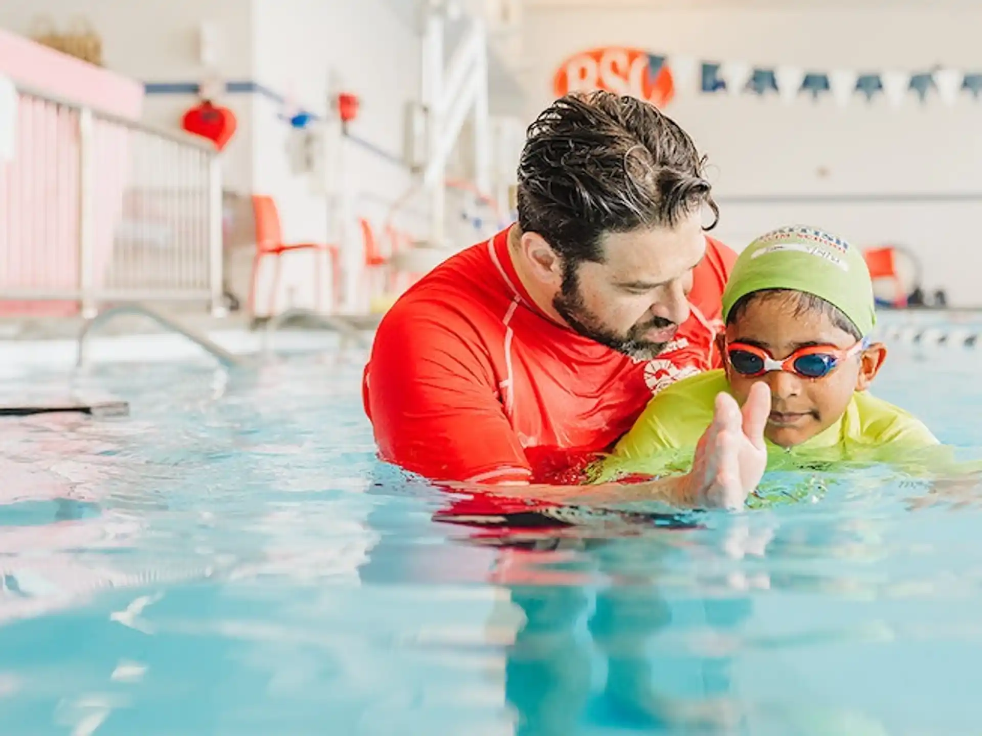 a man and a child in a pool