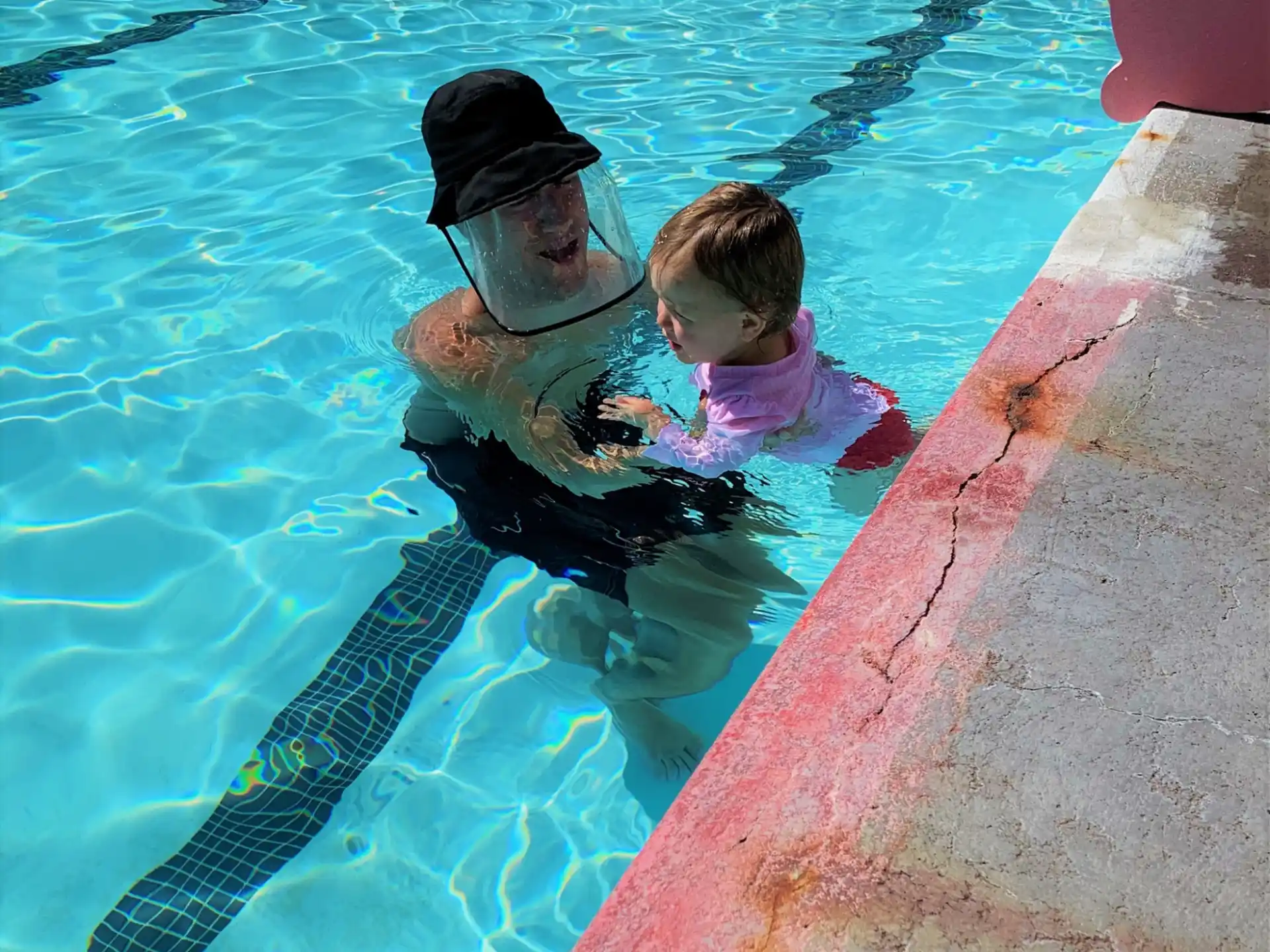a person and a child in a pool