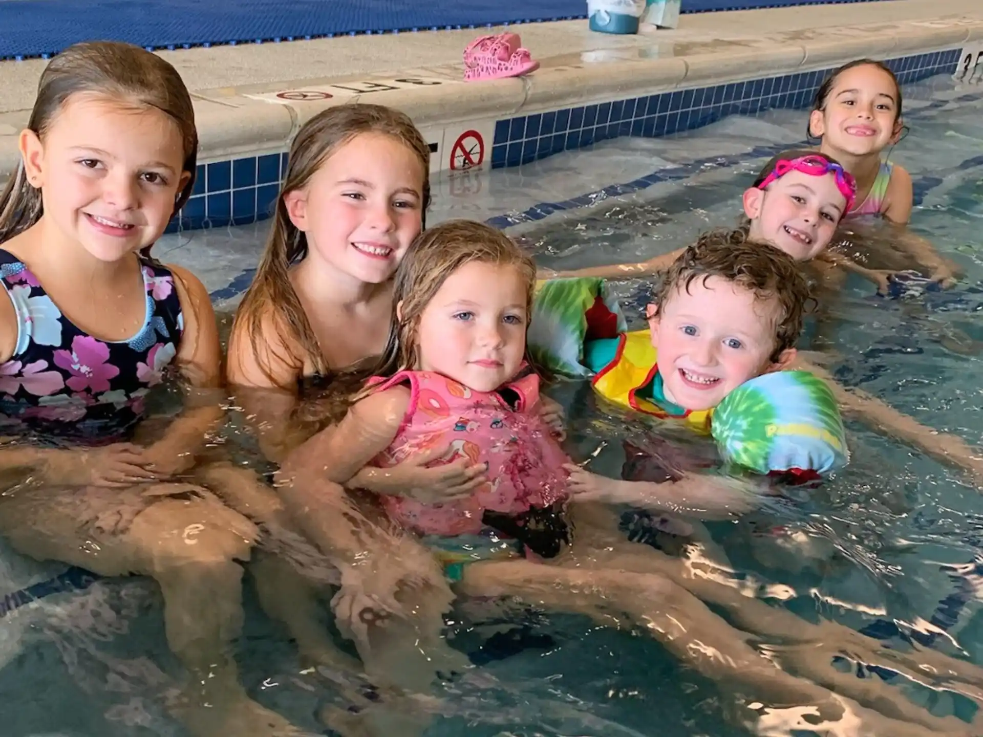 a group of children in a pool