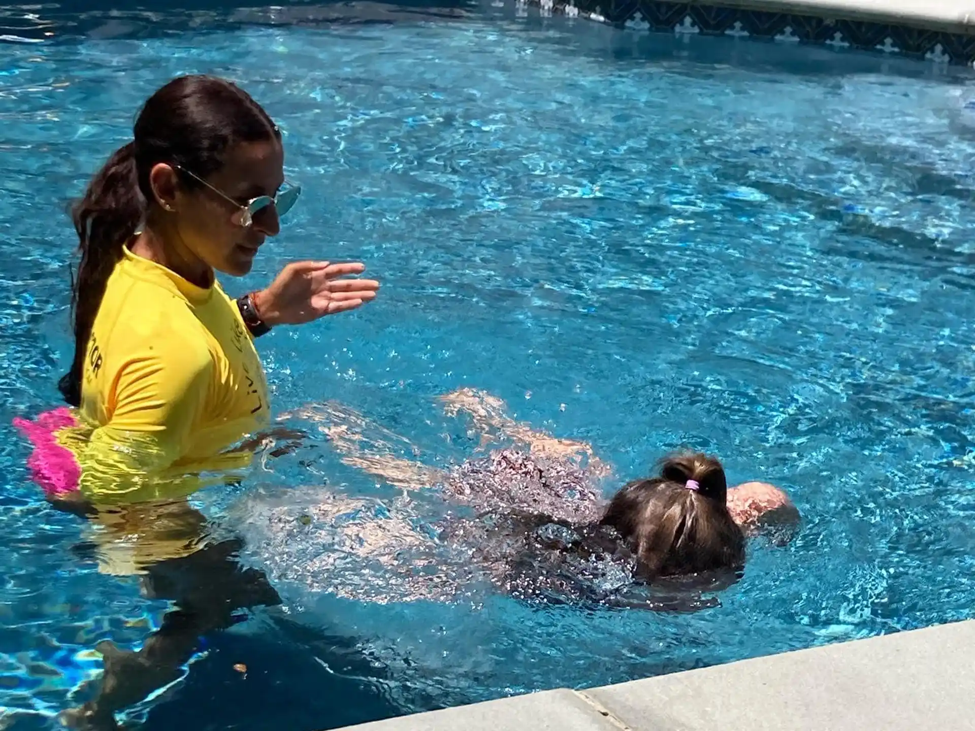 a person and a baby in a pool