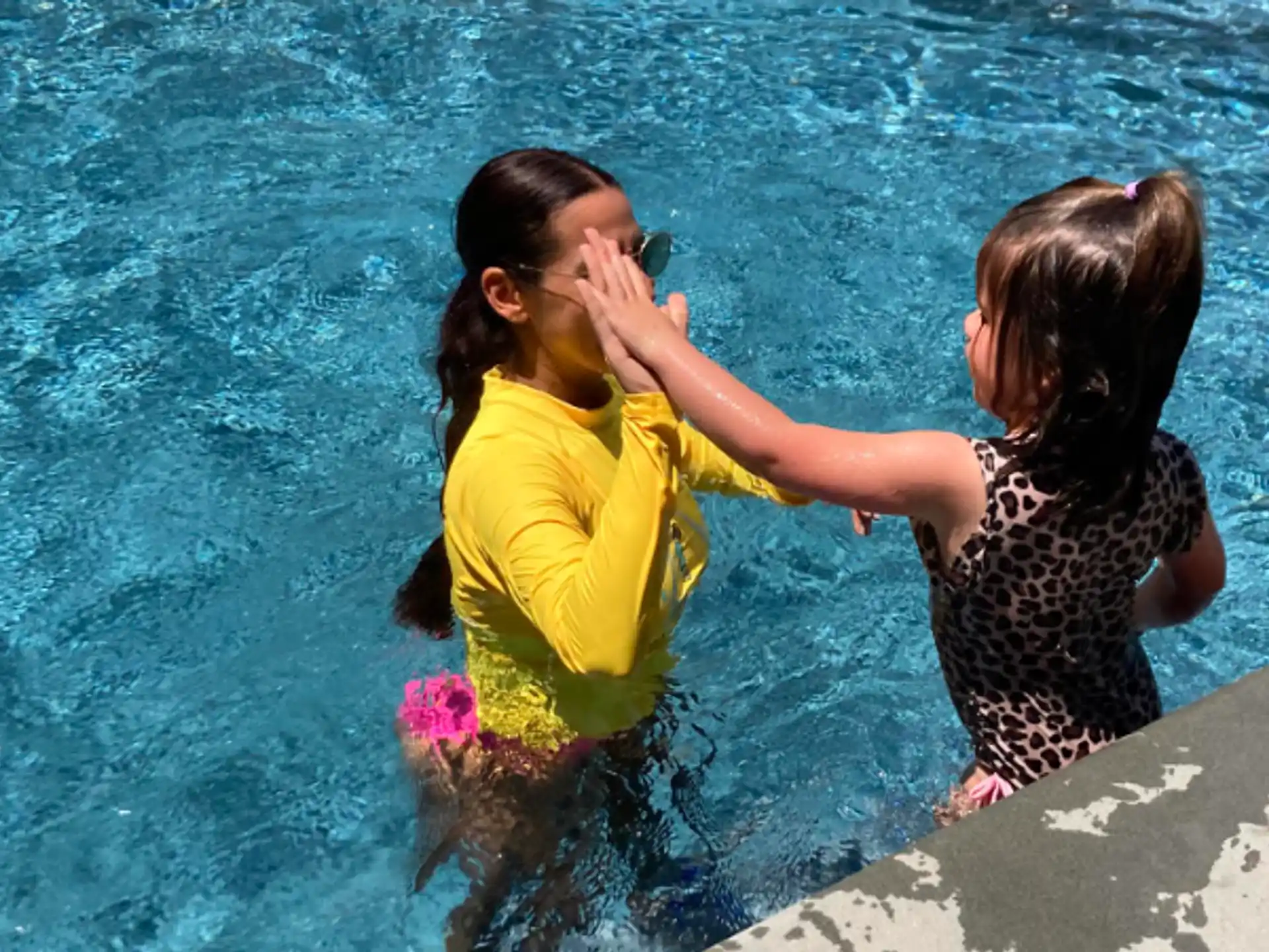 two girls kissing in water