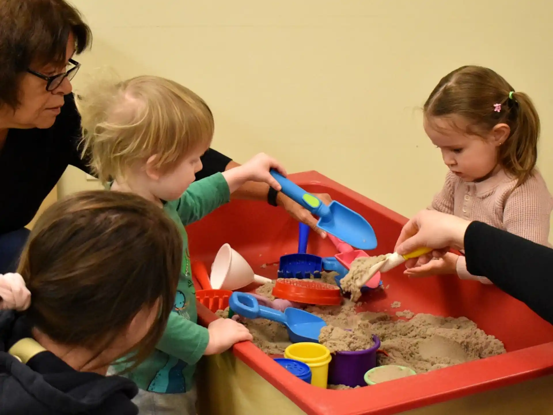 a group of children playing with sand