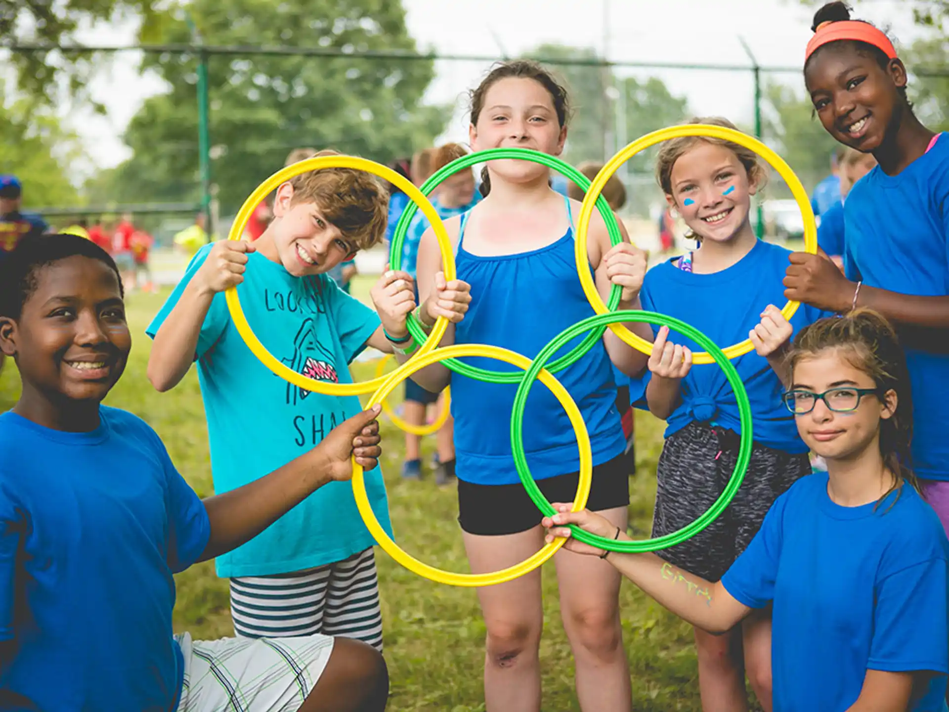 a group of people holding a hula hoop