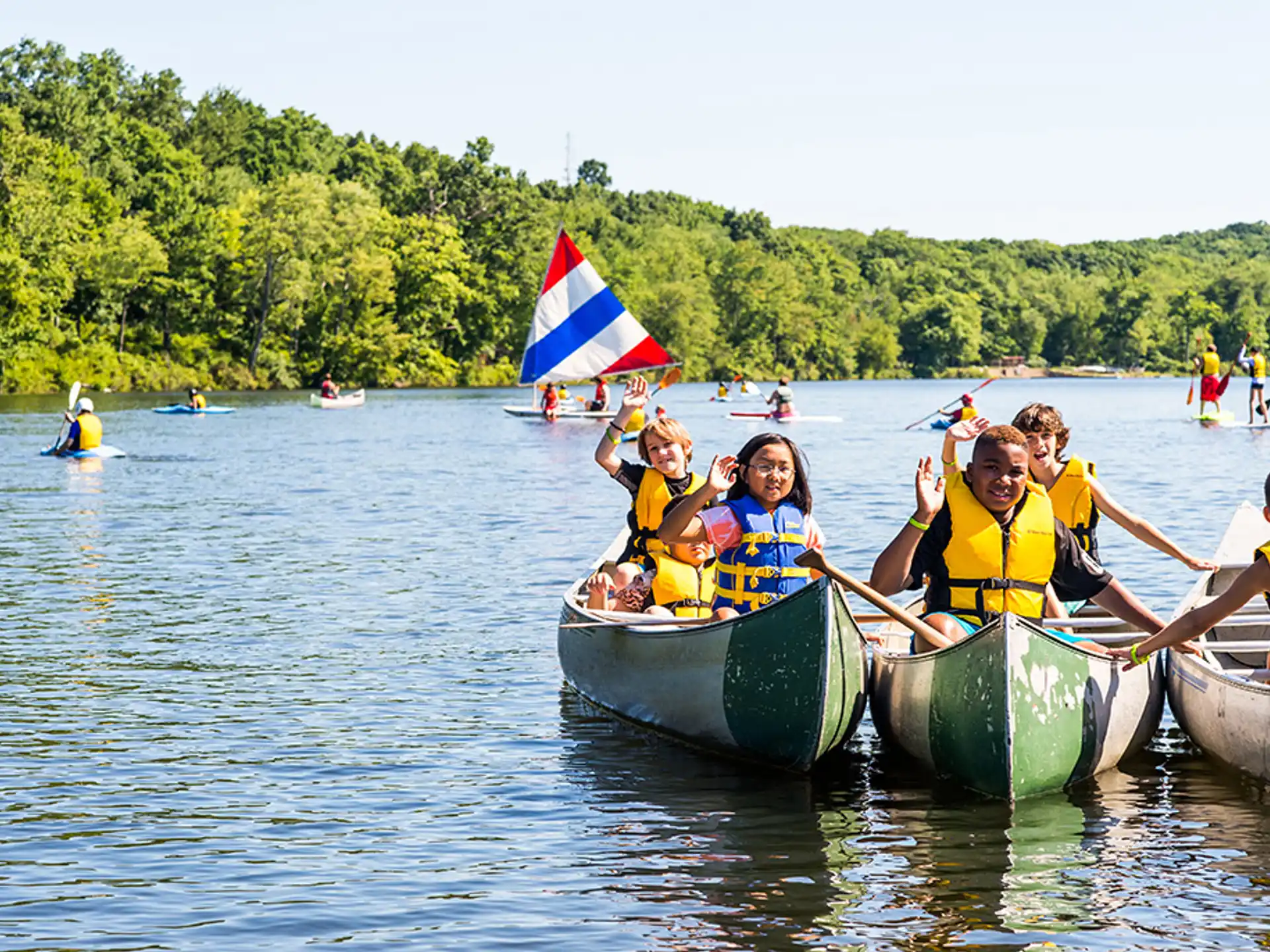 a group of people in canoes on a lake